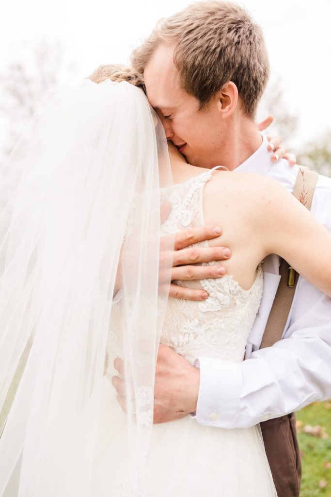 Groom embraces his bride after his wedding at at the Fork of Cheat Baptist Church in Morgantown, West Virginia.  Photo by Austin Wedding Photographers, Joanna & Brett
