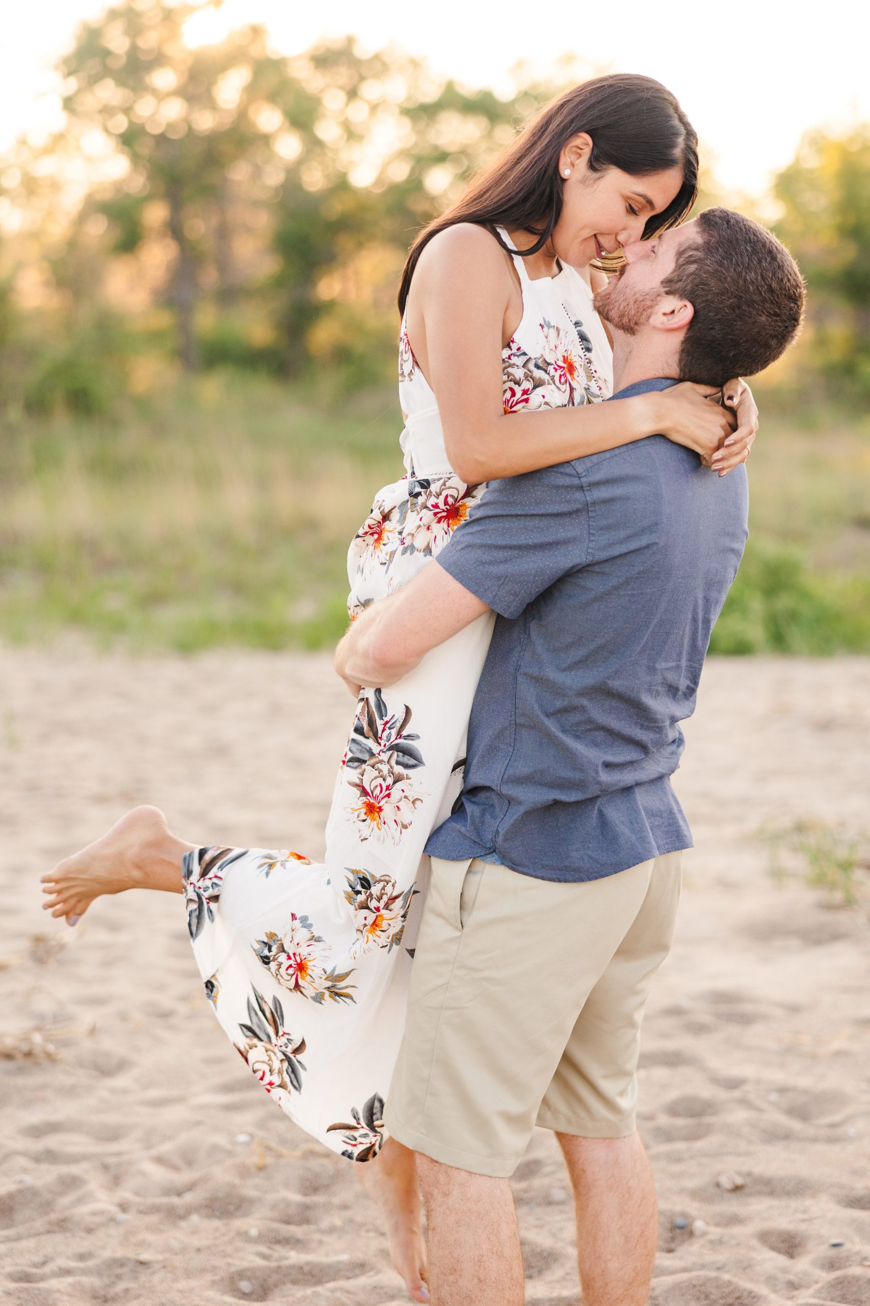 Couple celebrate their engagement at Illinois State Beach in Zion, Illinois. Photo taken by Austin Wedding Photographers, Joanna & Brett Photography