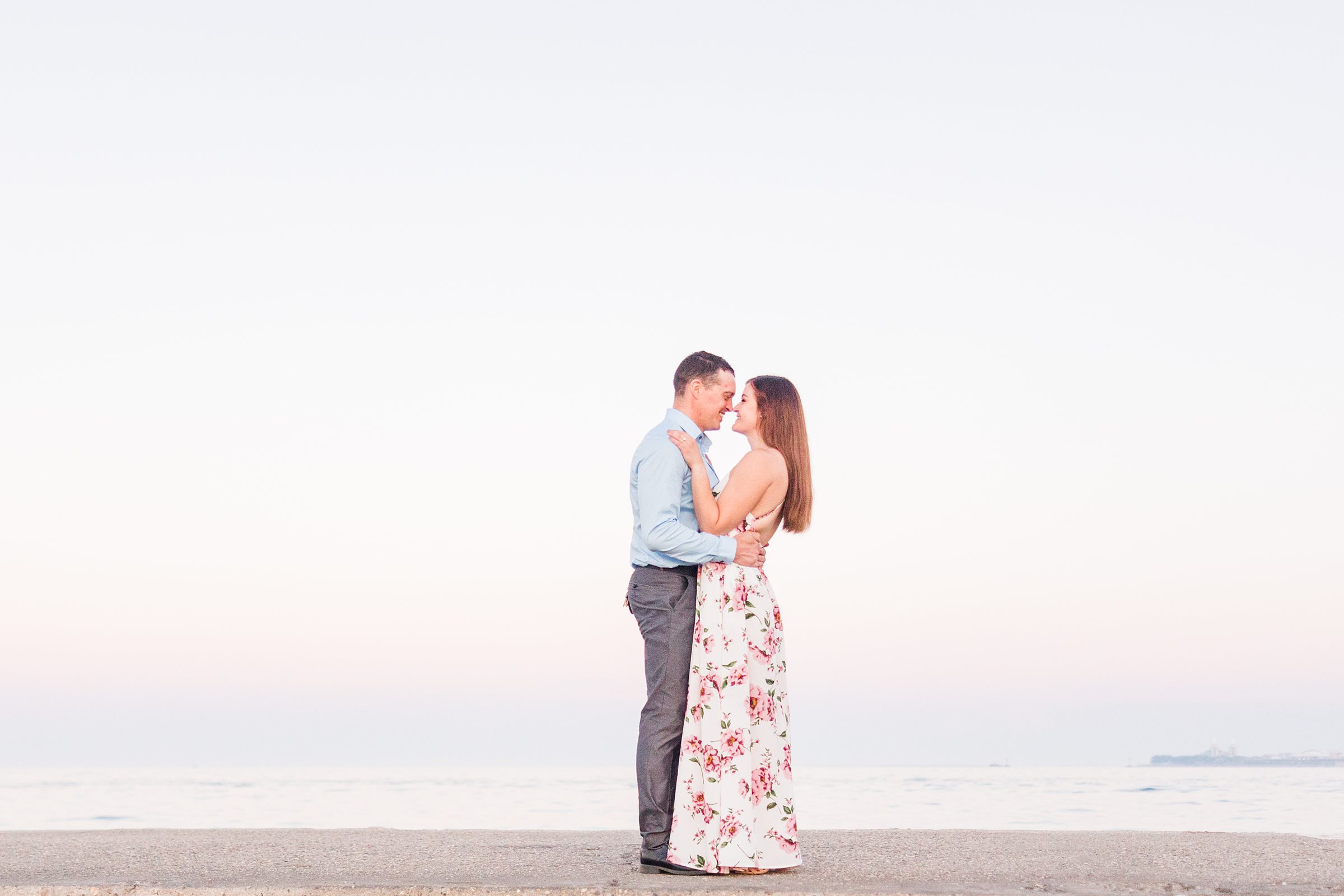 Couple celebrate their engagement at North Avenue Beach in Chicago, Illinois. Photograph taken by Illinois Wedding Photographers, Joanna and Brett Photography