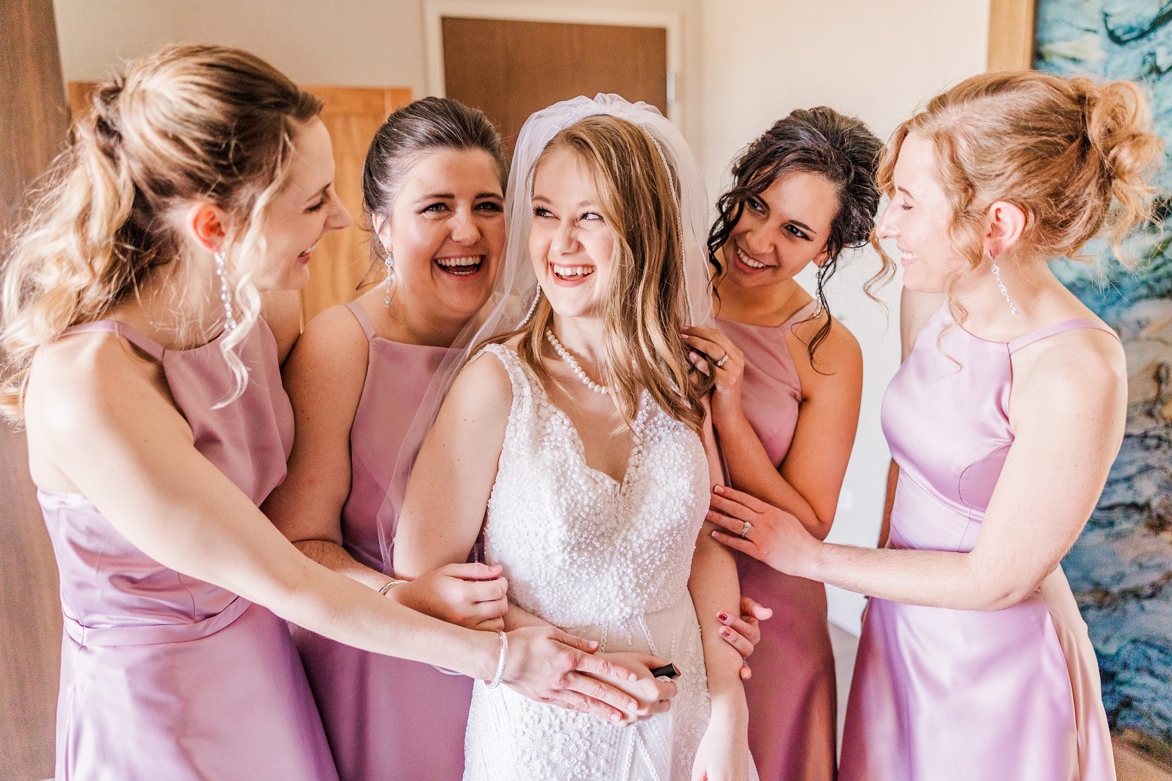 Bridesmaids see the bride for the first time during a wedding in Naperville, Illinois, Photo Taken by Austin Wedding Photographers, Joanna & Brett Photography