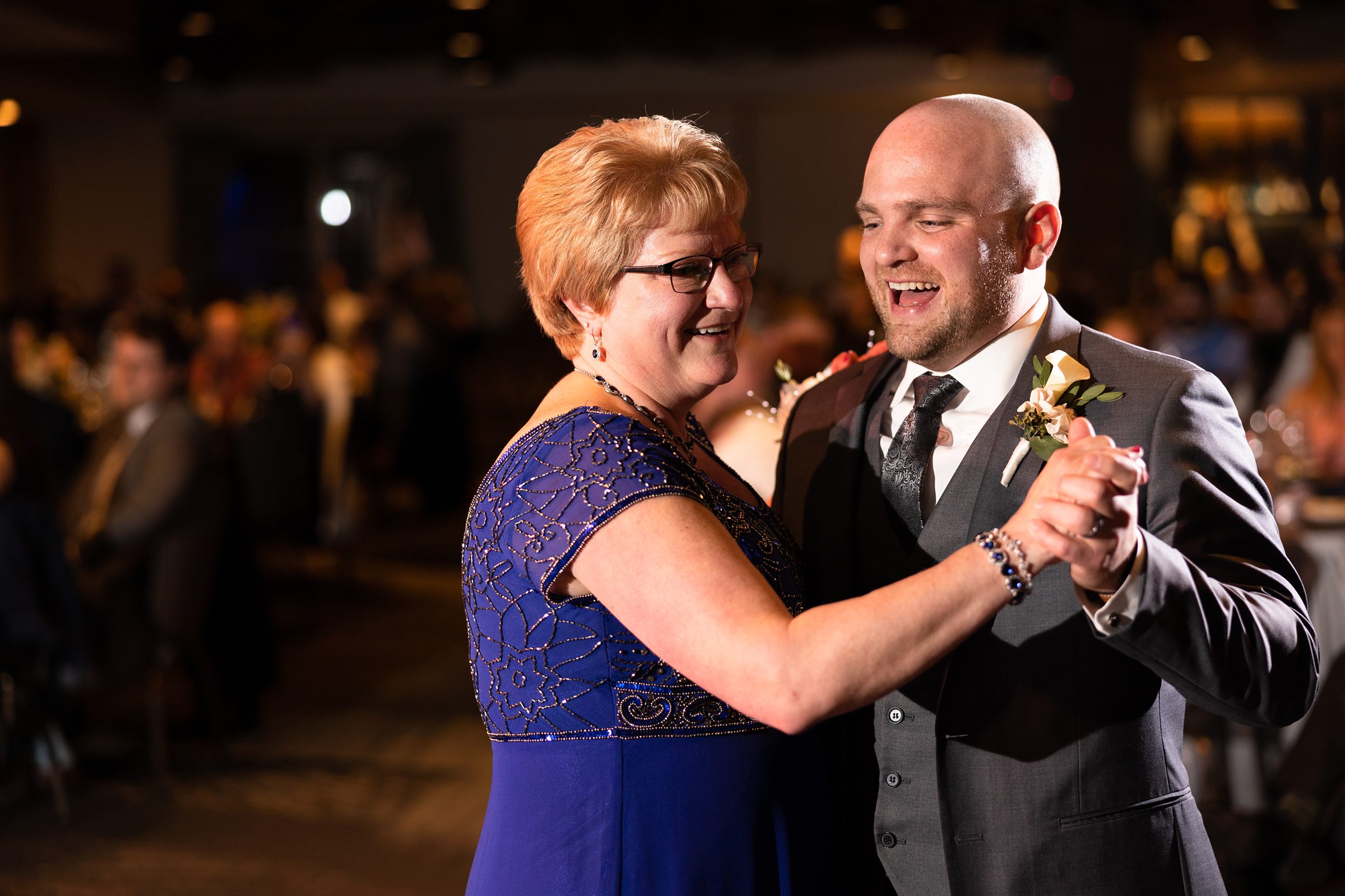 Groom dances with his mother at a wedding in Naperville, Illinois. Photo Taken by Austin Wedding Photographers, Joanna & Brett Photography