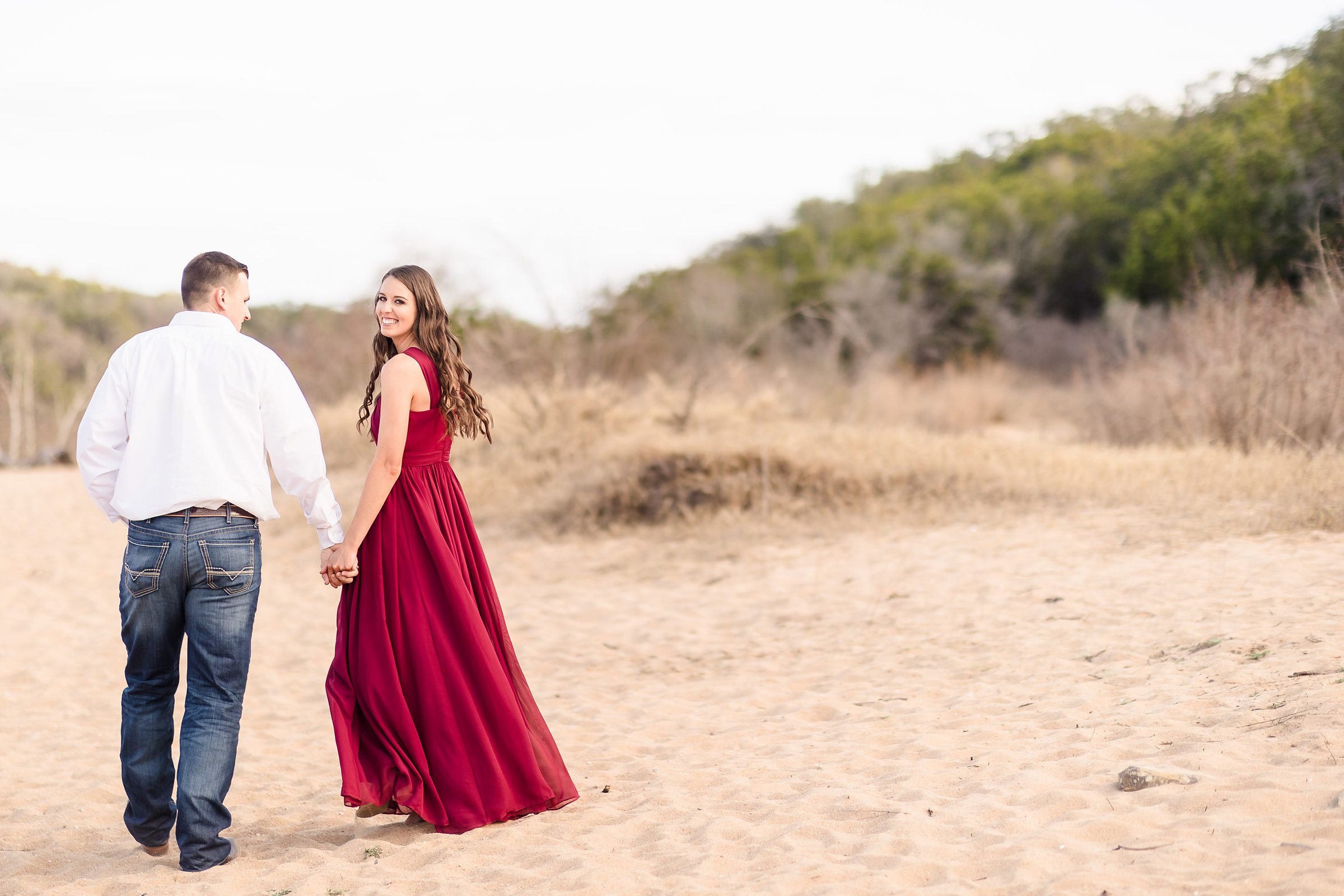 Couple celebrates their engagement at Padernales falls state park in Johnson City, Texas. Photograph taken by Austin Wedding Photographers, Joanna & Brett Photography