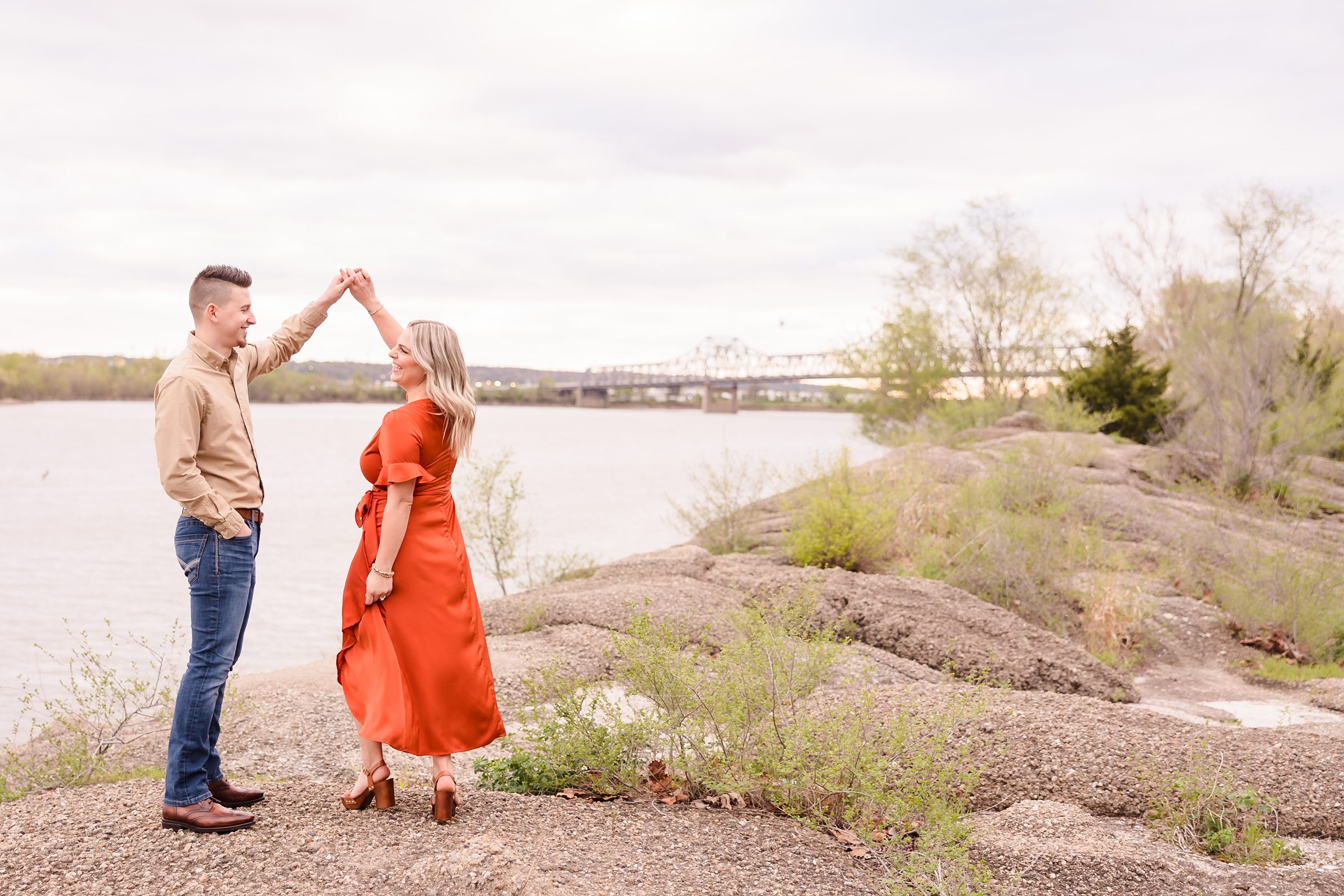 Couple celebrate their engagement at the riverfront in Peoria, Illinois. Photo taken by Illinois wedding photographers, Joanna & Brett
