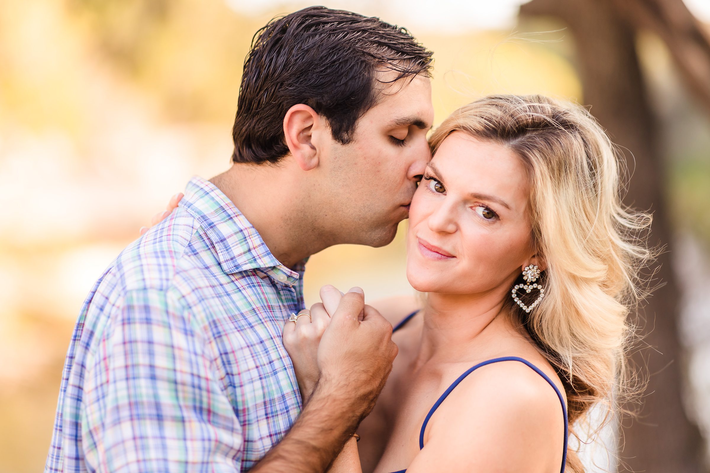 Couple Embrace during their engagement session at Bull Creek Park in Austin, Texas.
