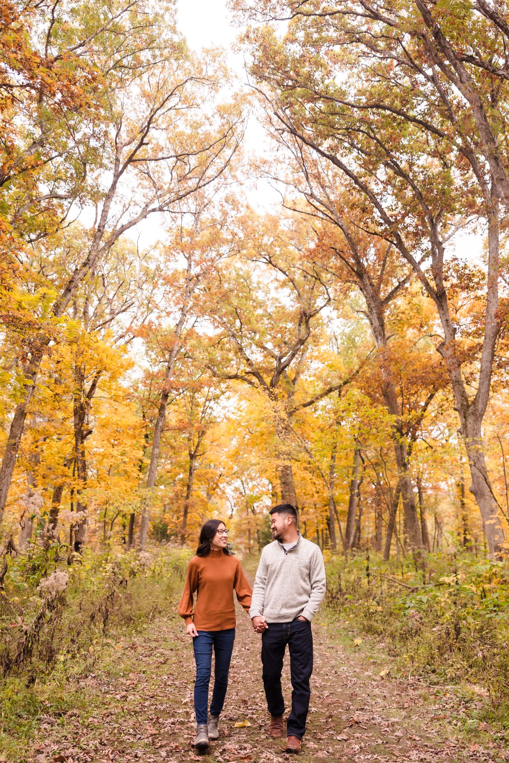 Couple walk together during their engagement session at Allerton Park in Monticello, Illinois.
