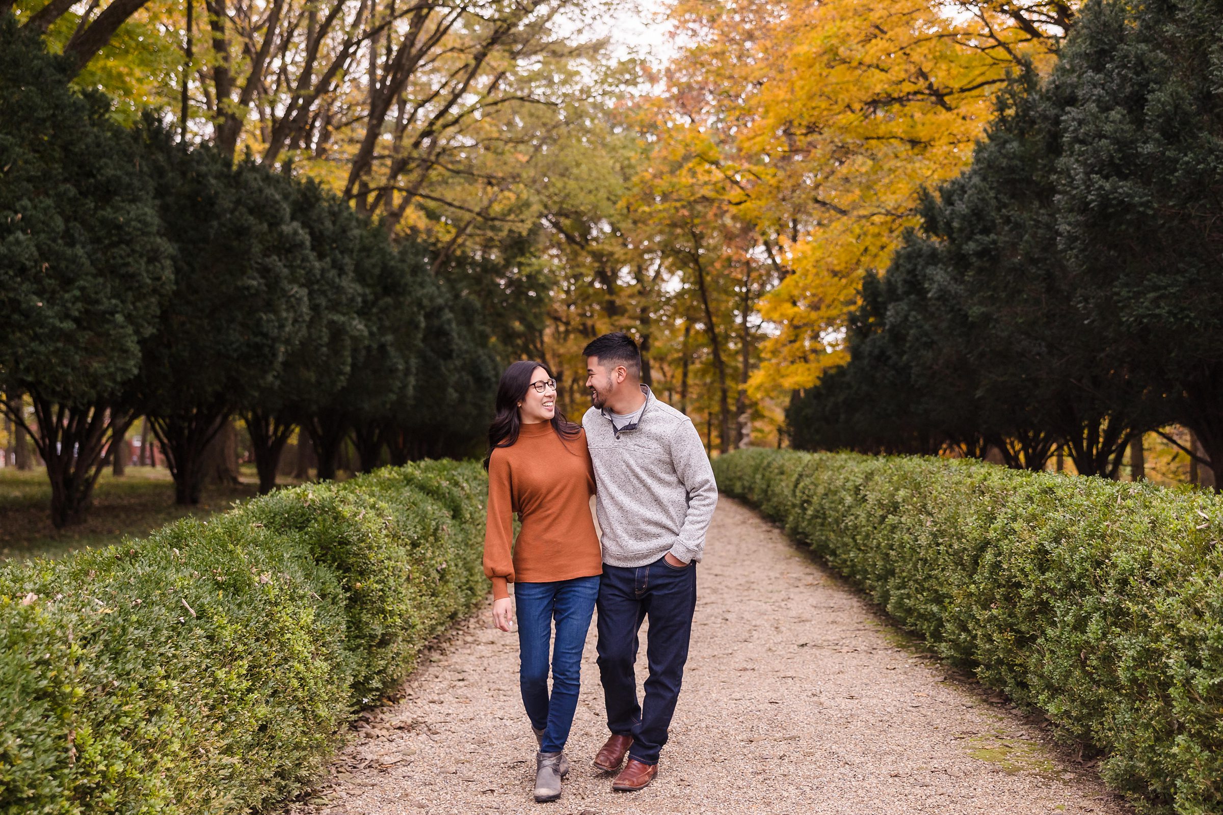 Couple walk together during their engagement session at Allerton Park in Monticello, Illinois.