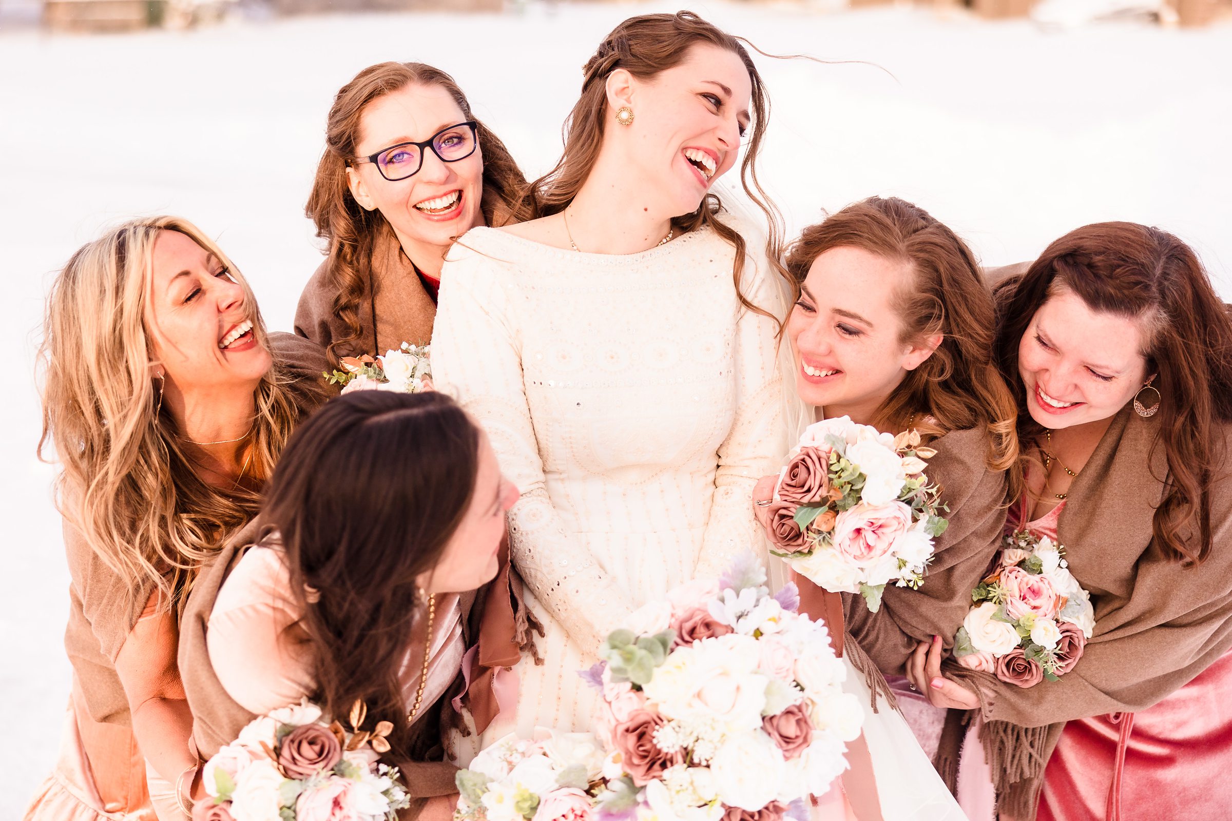 Bridesmaids hugs the bride during her wedding in Bloomington-Normal, Illinois.