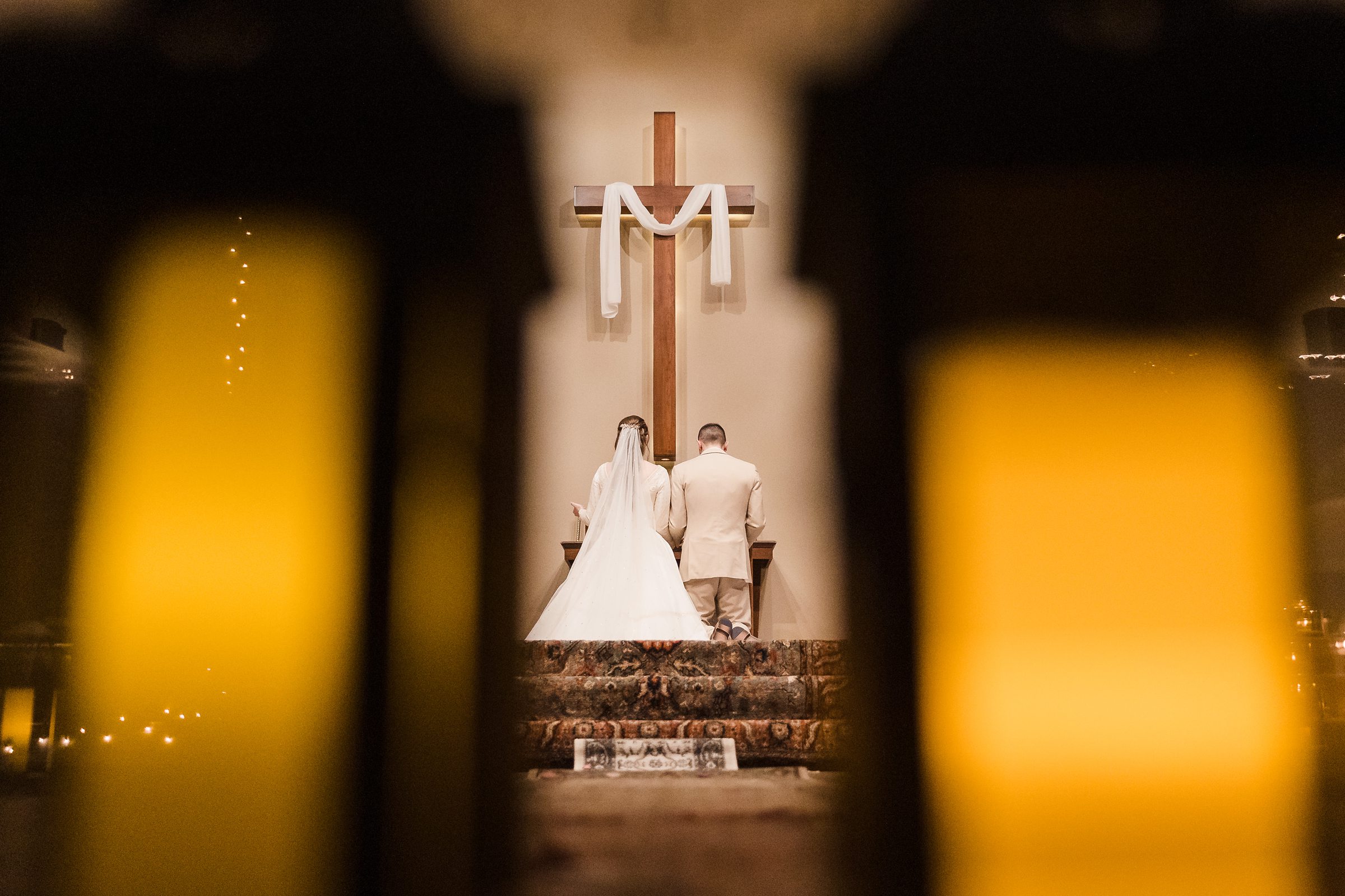 Bride and groom pray during their wedding ceremony in Bloomington-Normal, Illinois