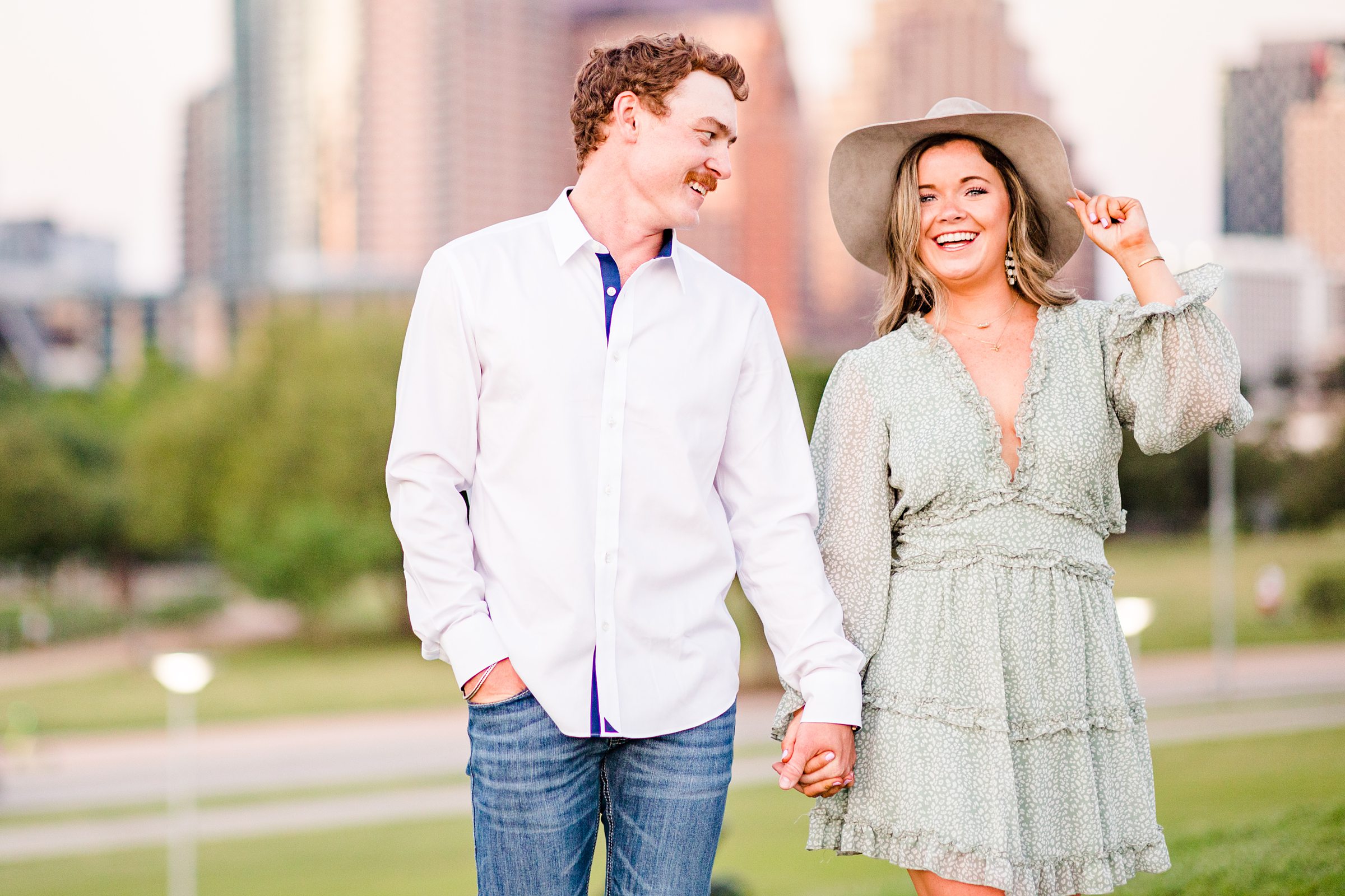 Couple walk together during their engagement session at Butler Park in Austin, Texas.
