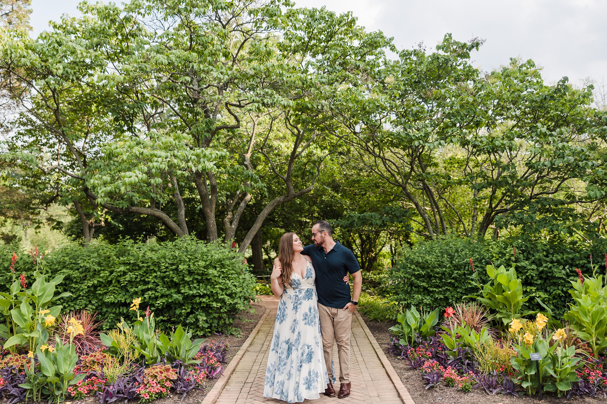 Couple walk together during their engagement session at Cantigny Park in Wheaton, Illinois.