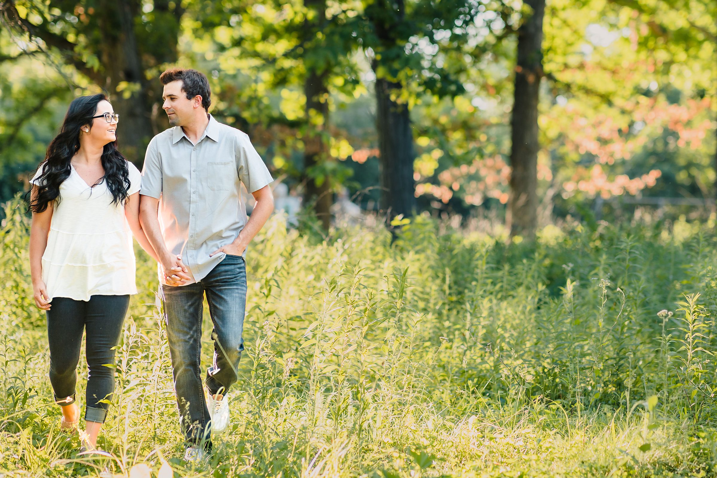 Couple walk together during their engagement session at the Chain O Lakes State Park in Fox Lake, Illinois.