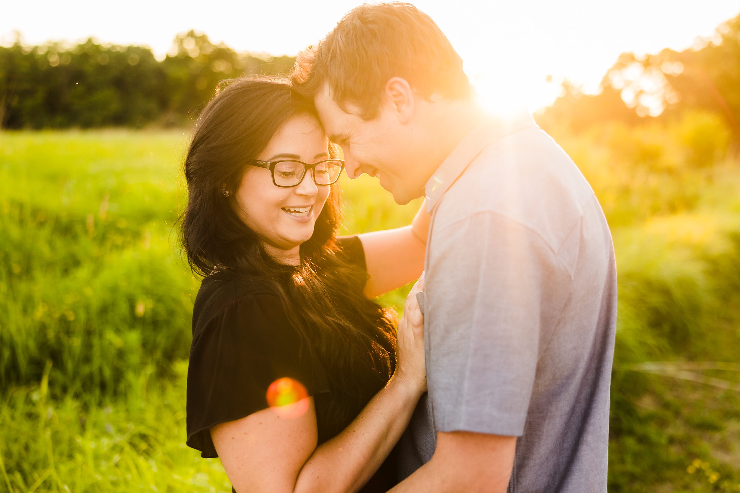 Couple embrace during their engagement session at the Chain O Lakes State Park in Fox Lake, Illinois.