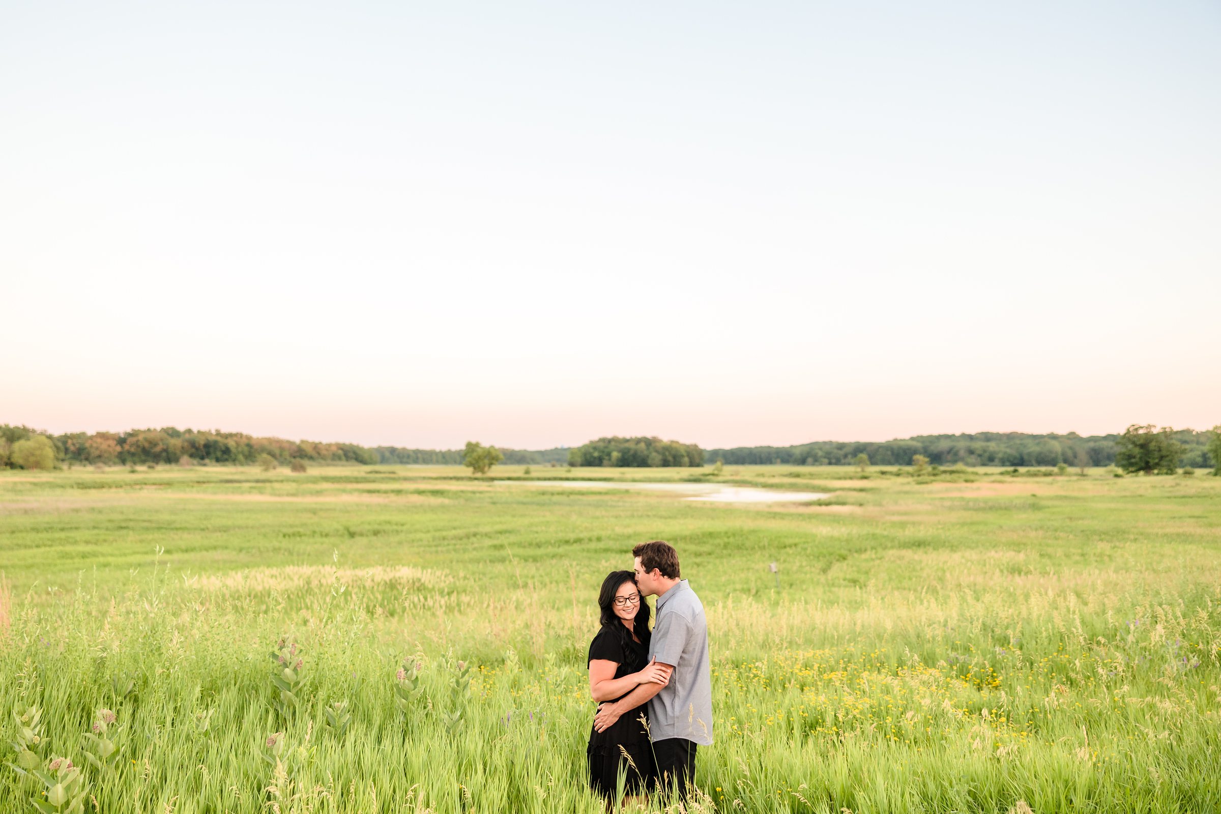 Couple embrace during their engagement session at the Chain O Lakes State Park in Fox Lake, Illinois.