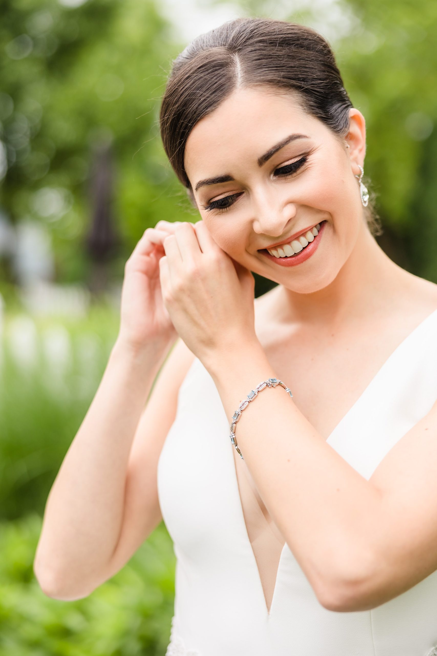 Bride puts her earrings in before her wedding at the Chevy Chase Country Club in Wheeling, Illinois.
