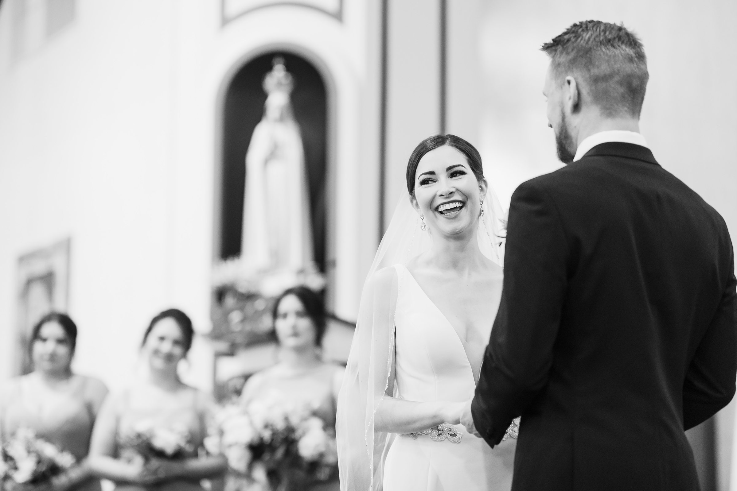 Bride laughs during her wedding at Our Lady of the Wayside Church in Illinois.