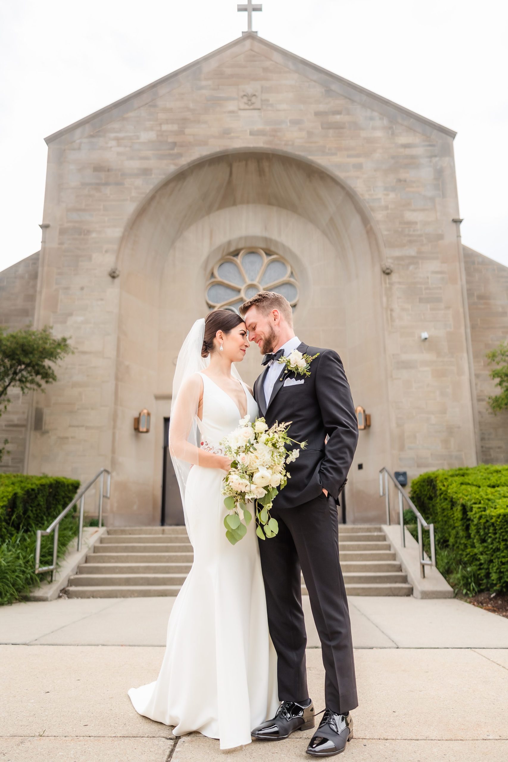 Bride and groom embrace after their wedding ceremony at Our Lady of the Wayside Church in Illinois.
