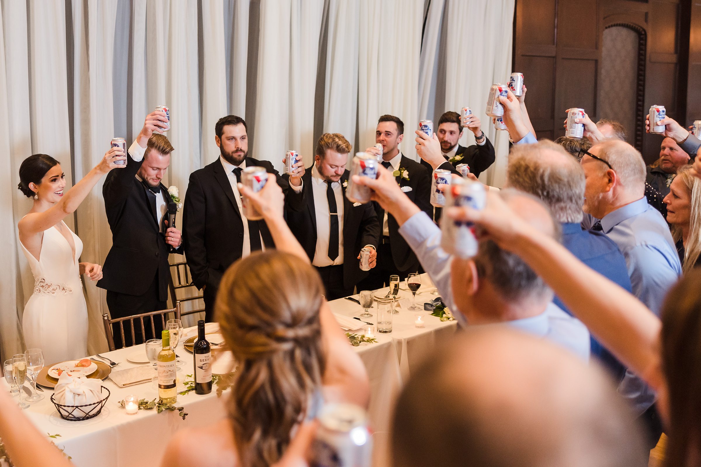 Everyone toasts the groom's father, who passed away, during a wedding at the Chevy Chase Country Club in Wheeling, Illinois.