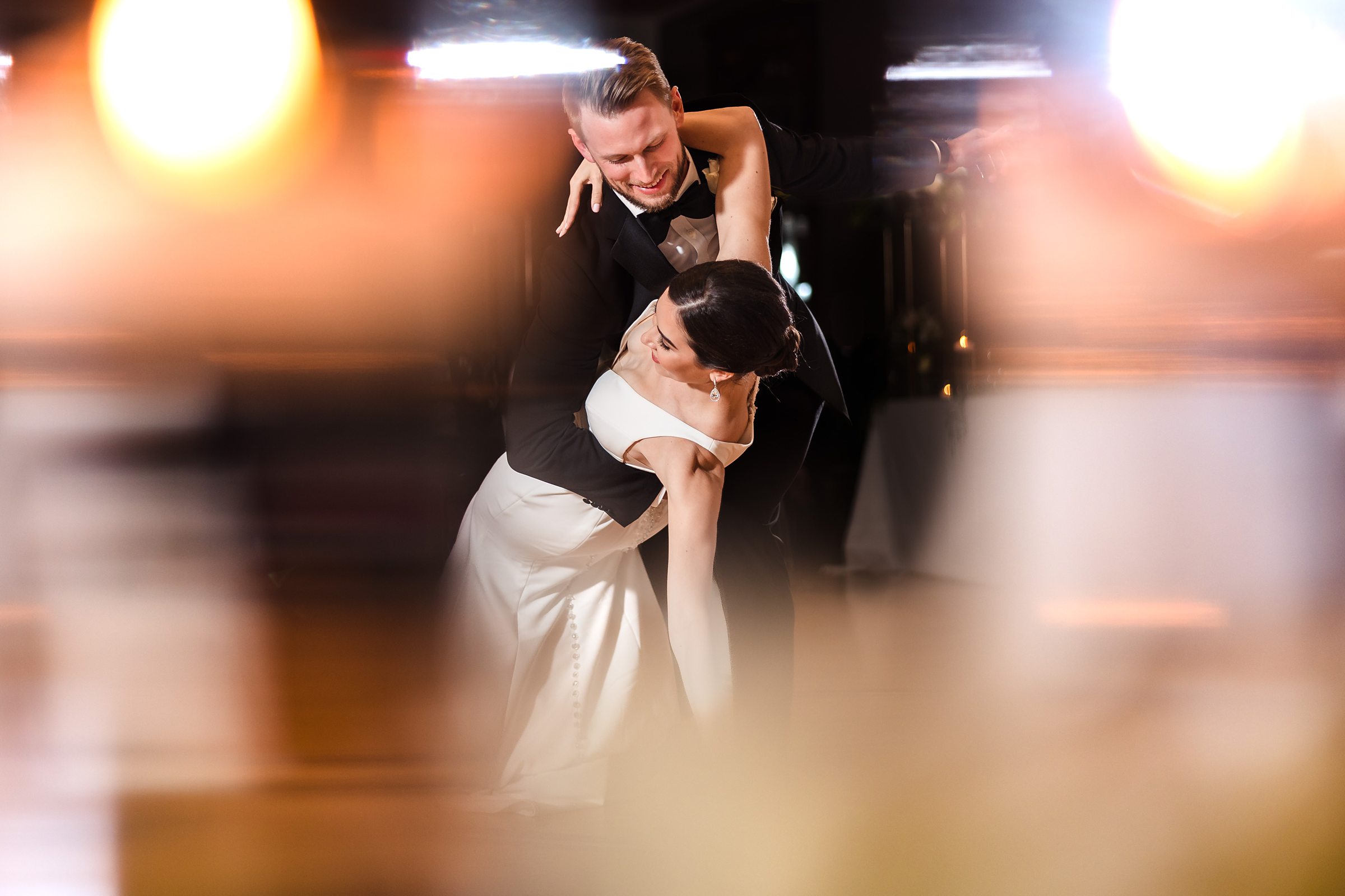 Groom dips the bride during their first dance at the Chevy Chase Country Club in Wheeling, Illinois.