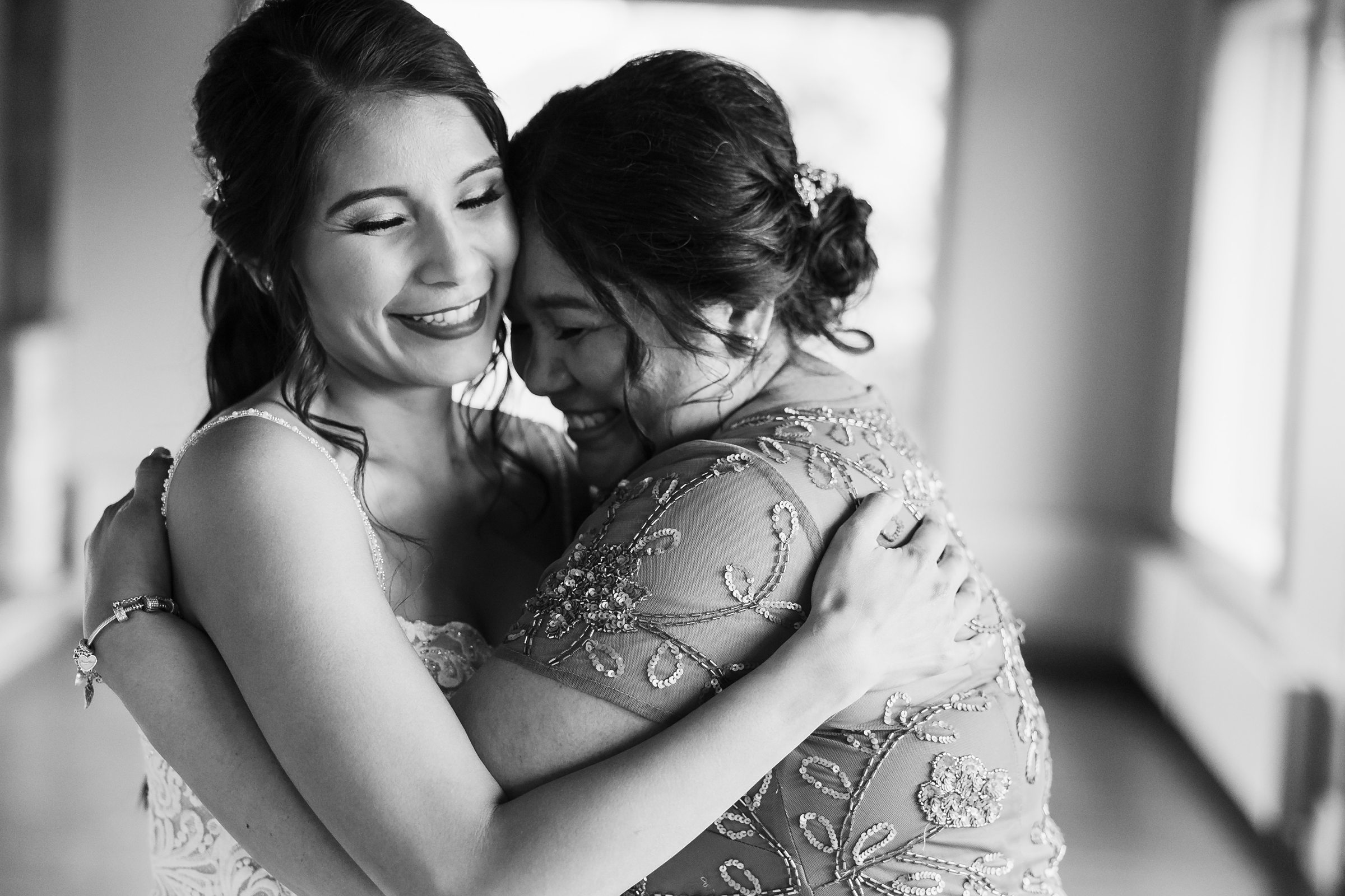 Bride hugs her mother during her wedding at the Fisherman's Inn in Elburn, Illinois.
