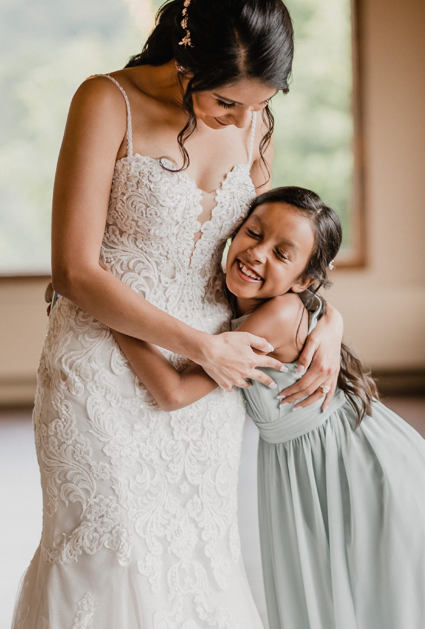 Bride hugs her daughter during her wedding at the Fisherman's Inn in Elburn, Illinois.