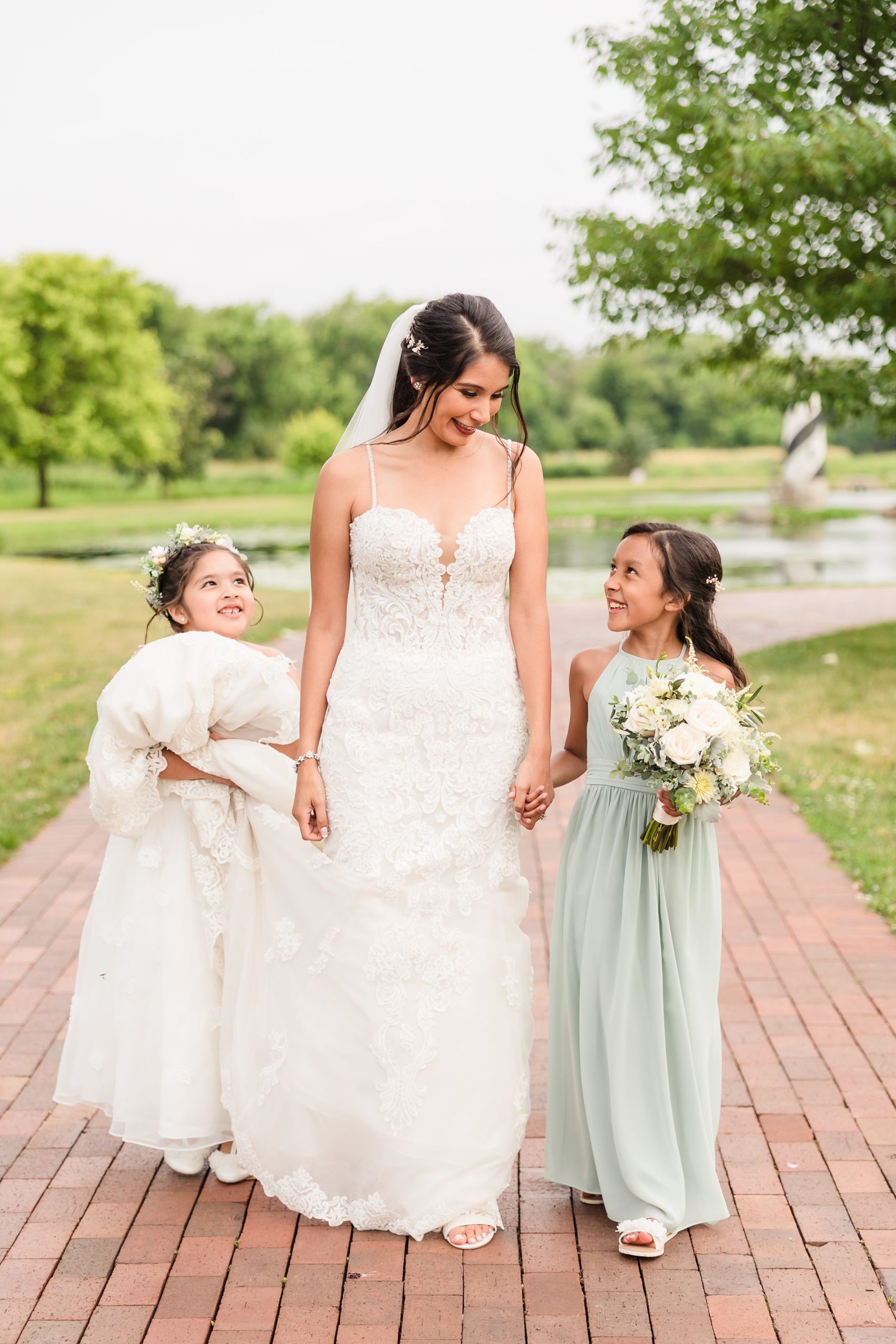Bride walks with her flower girls during her wedding at the Fisherman's Inn in Elburn, Illinois.