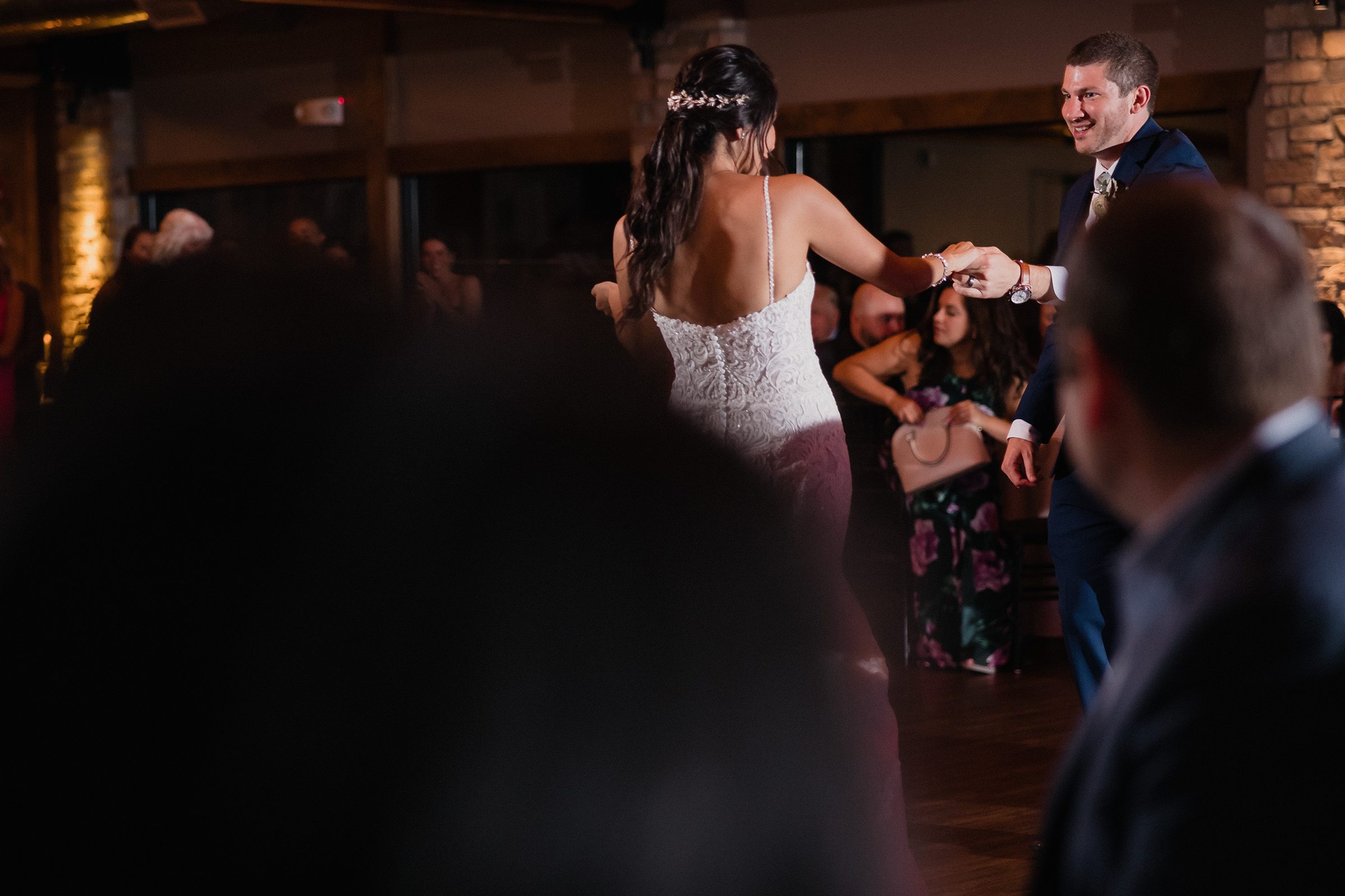 Groom twirls the bride while dancing during their wedding at the Fisherman's Inn in Elburn, Illinois.