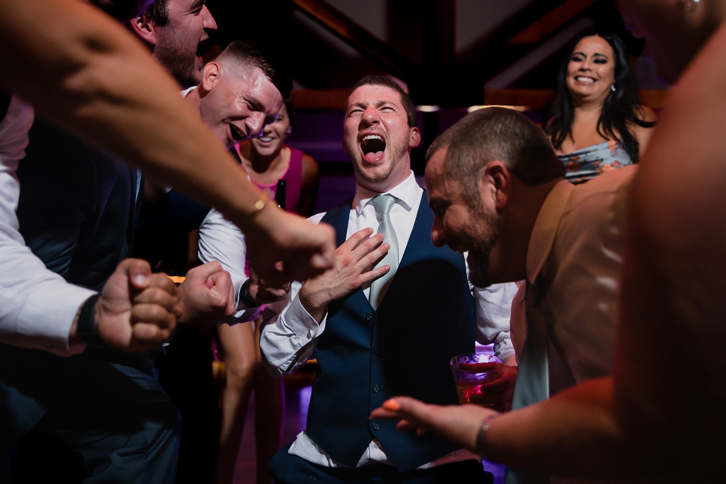 Groom yells with excitement during his wedding at the Fisherman's Inn in Elburn, Illinois.