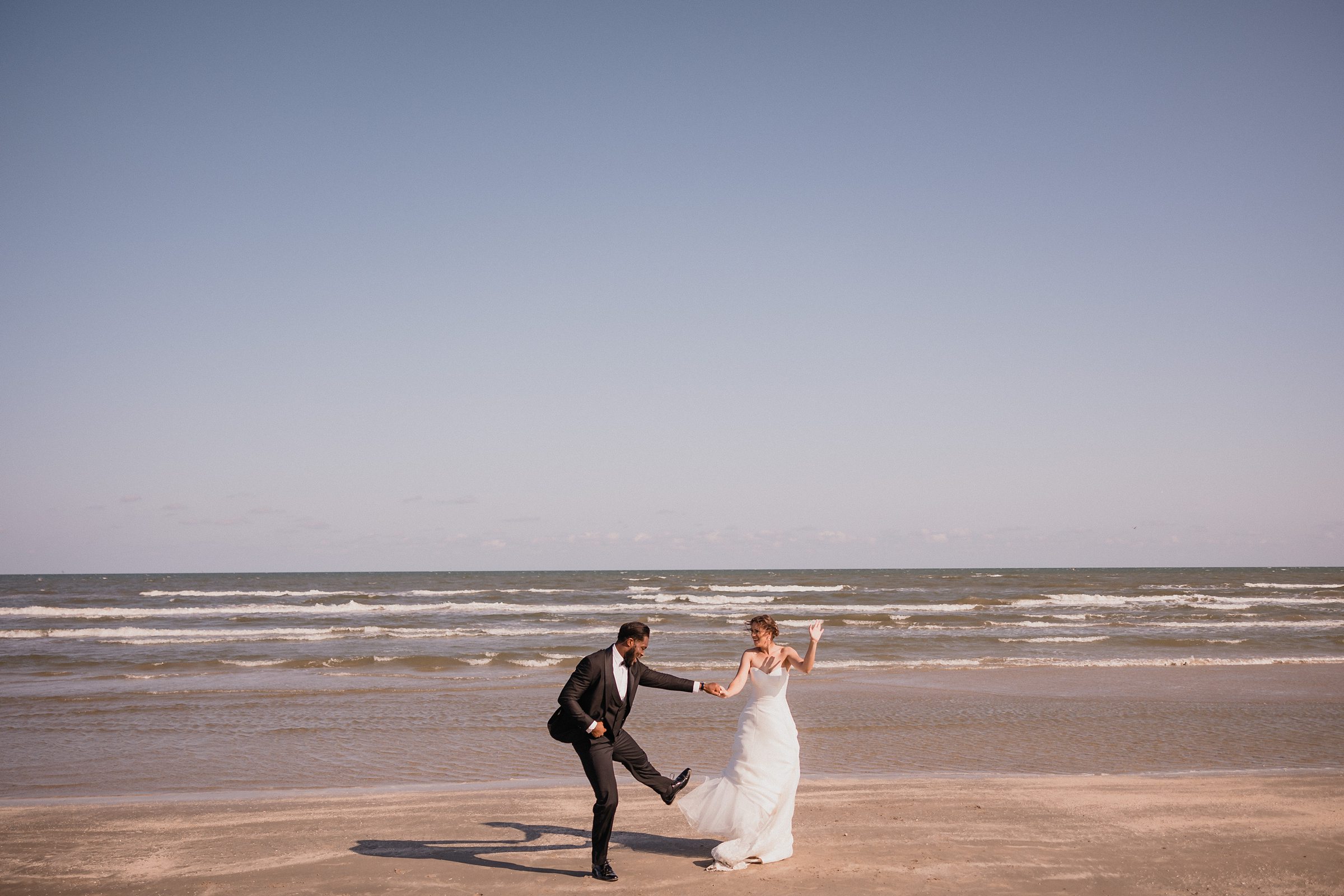 Bride and Groom dance together during an elopement in Galveston Beach, Texas