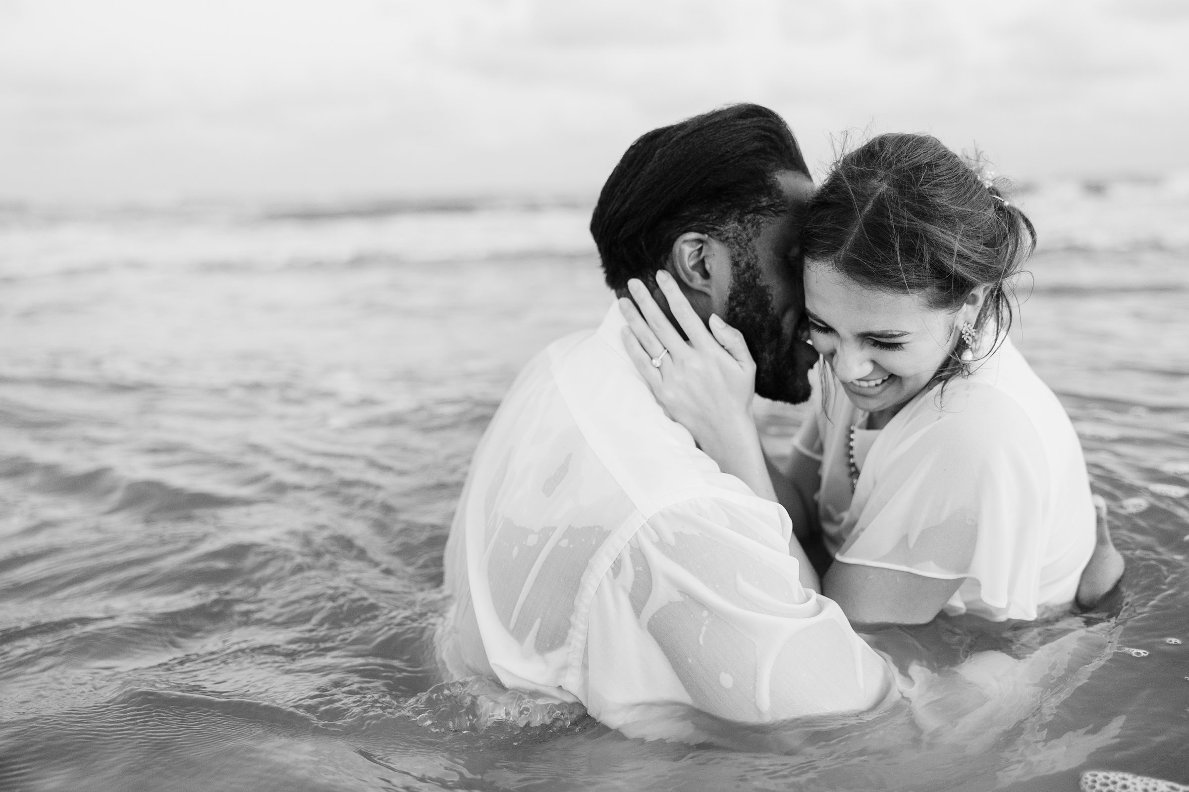 Couple embrace during their session at Galveston Beach in Texas.