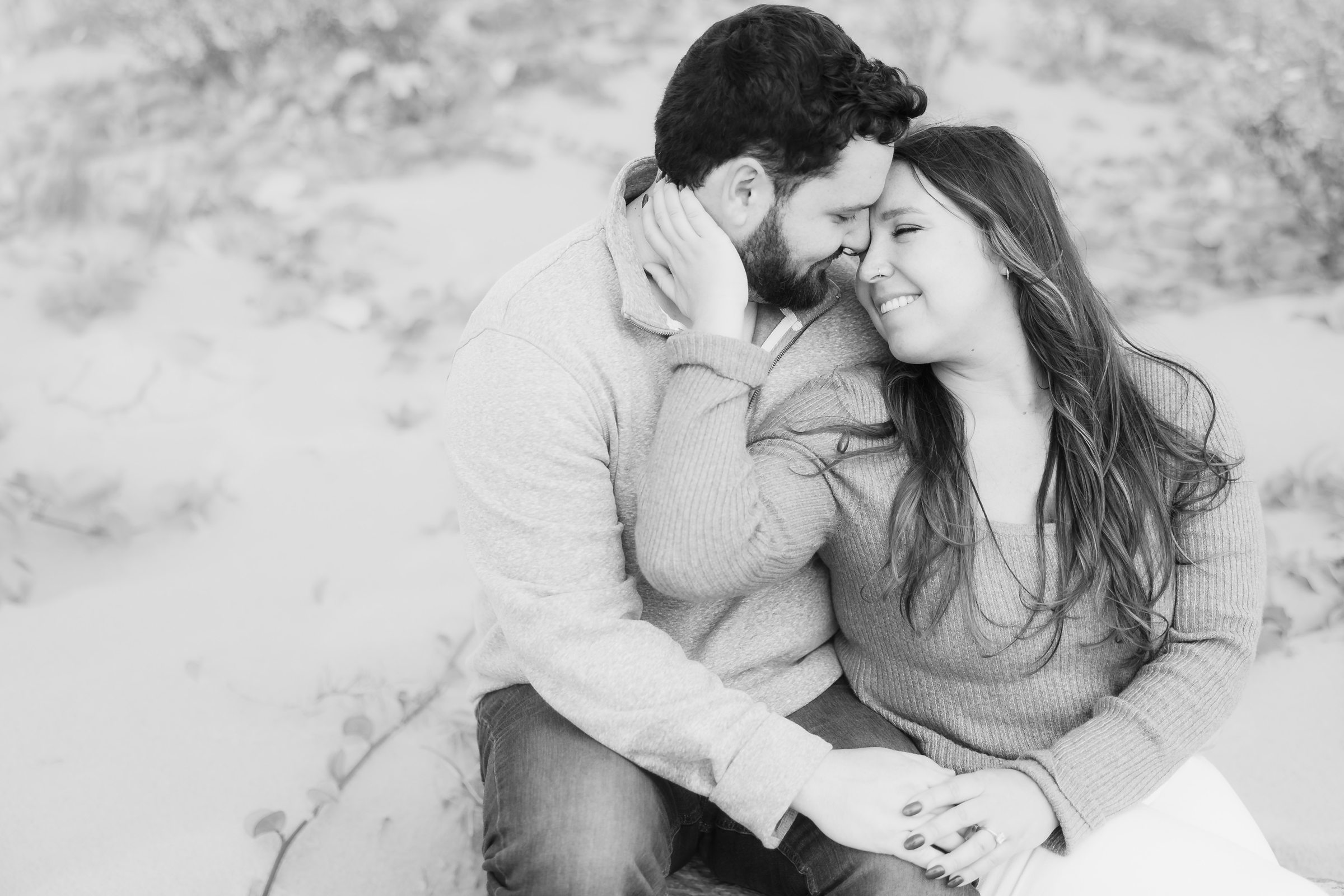 Couple embrace during their Galveston Beach engagement session.