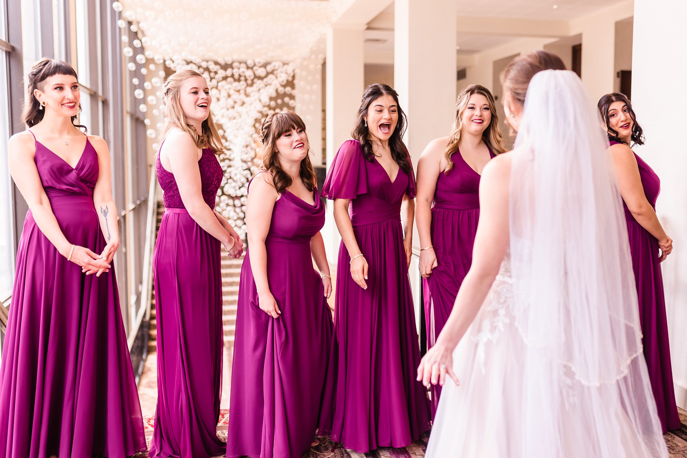 Bridesmaids see the bride before the wedding at the Hotel Pere Marquette in Peoria, Illinois.
