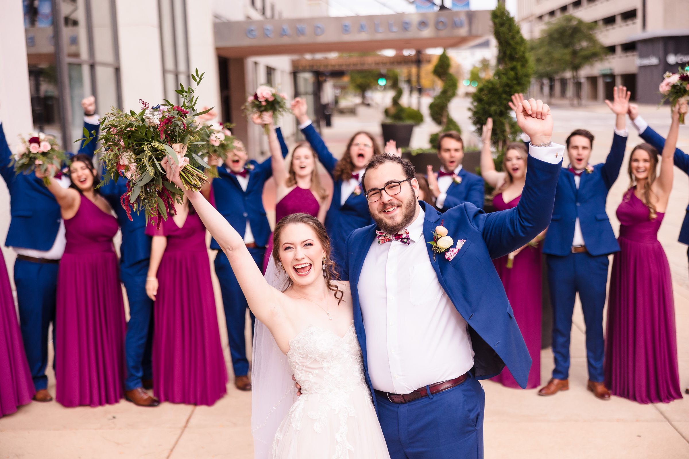 Bridal party celebrate with the couple at the Hotel Pere Marquette in Peoria, Illinois.