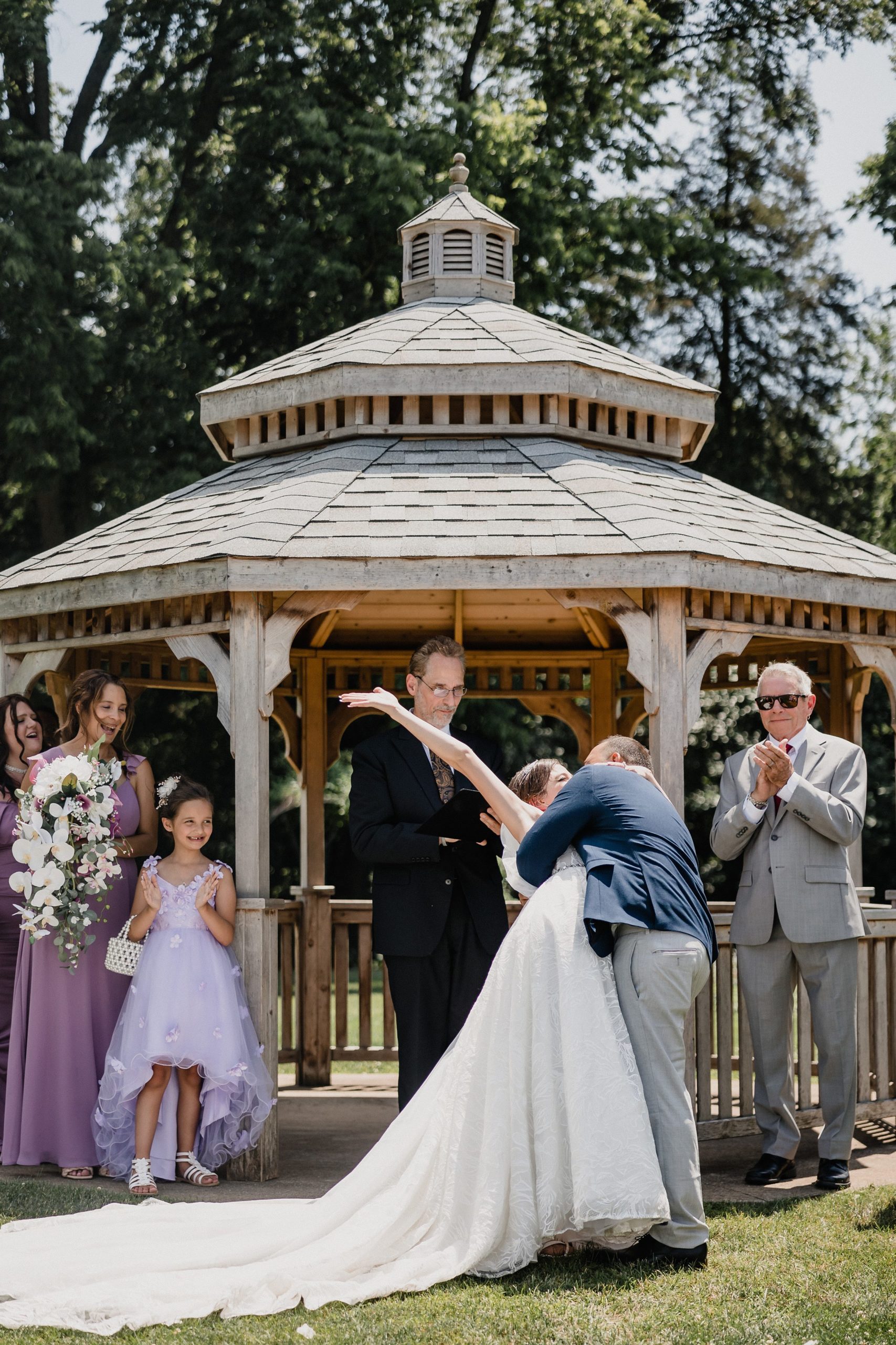 Bride and groom share a first kiss during their wedding at the Bird Haven Greenhouse & Conservatory in Joliet, Illinois.