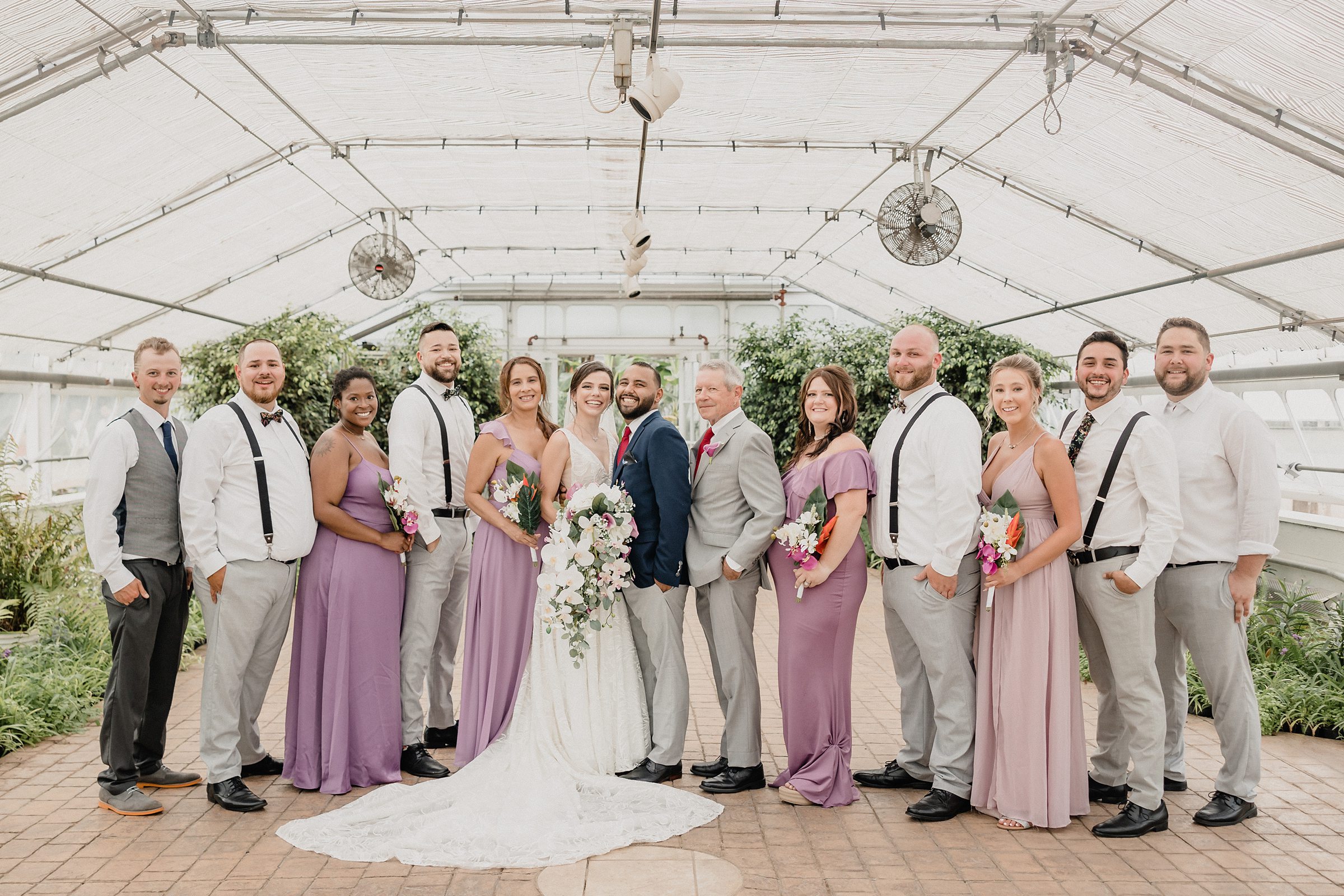Full bridal party during a wedding at the Bird Haven Greenhouse & Conservatory in Joliet, Illinois.