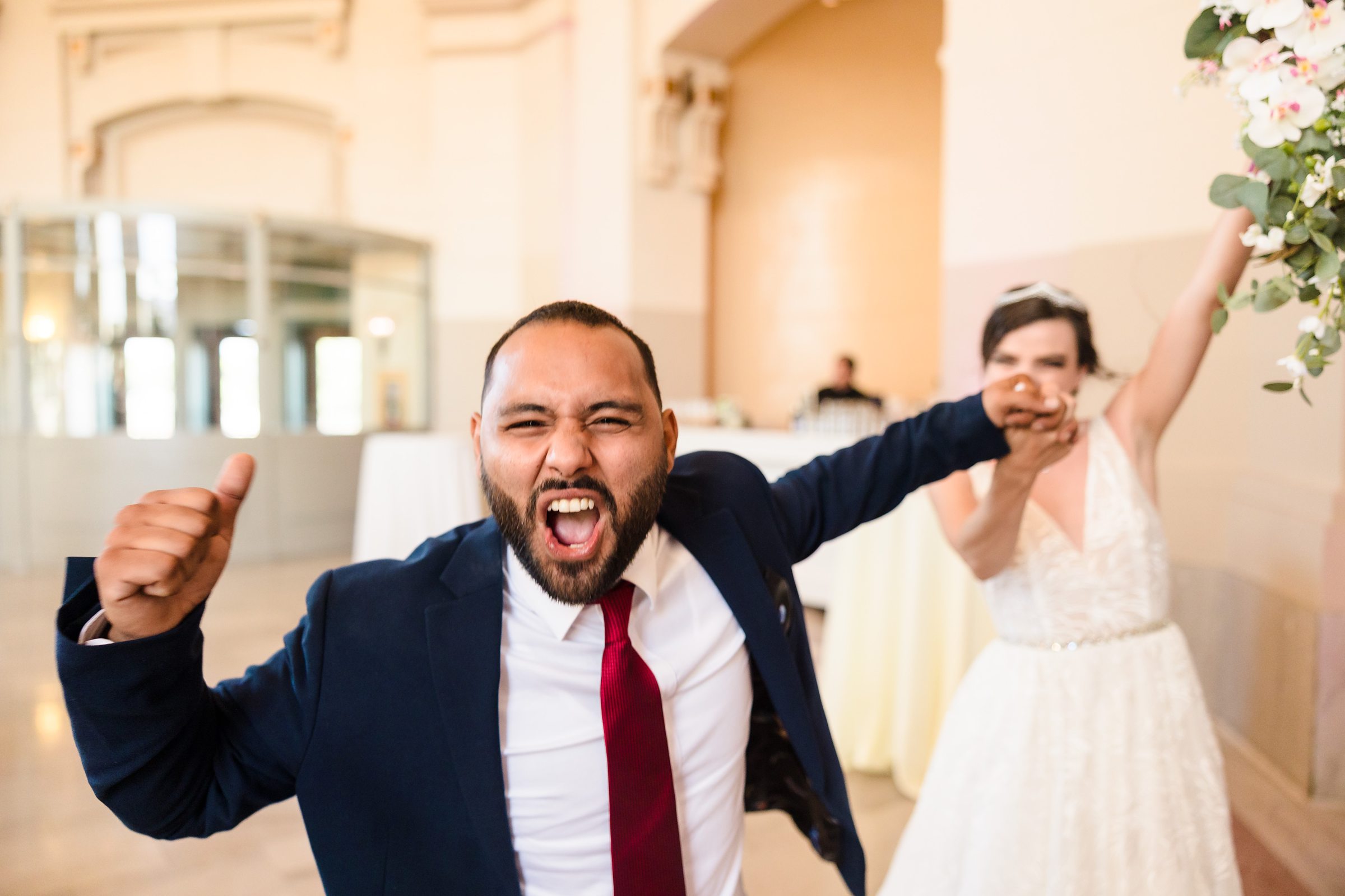 Bride and groom celebrate during their grand enterance at the Union Station in Joliet, Illinois.