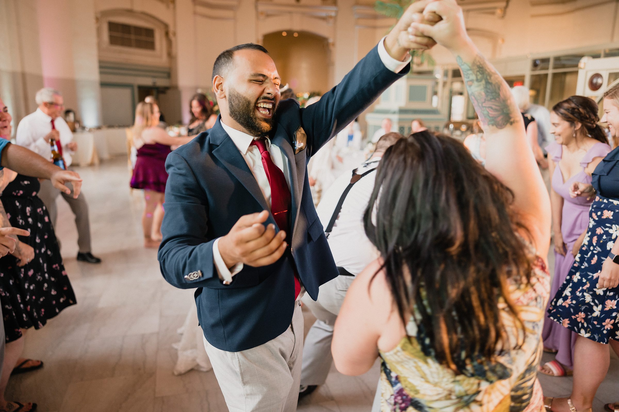 Groom dances on the dance floor during a wedding at the Union Station in Joliet, Illinois