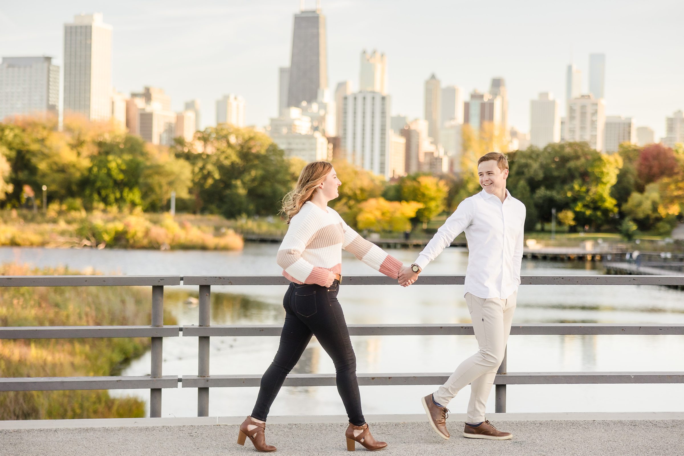 Couple walks together during their engagement sessionat Lincoln Park in Chicago, Illinois.
