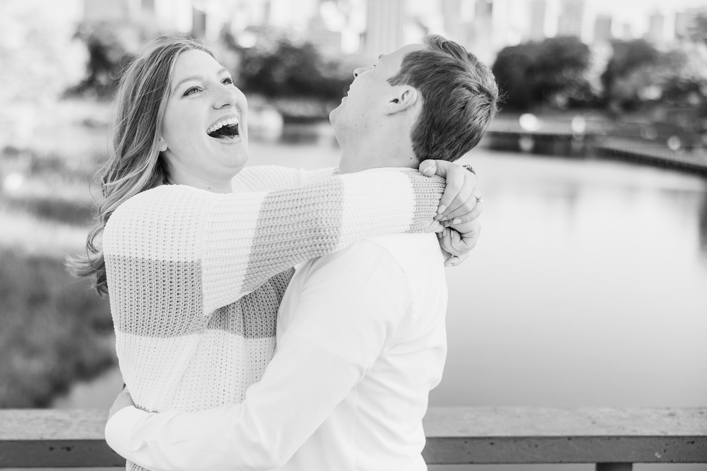 Couple laugh together during their engagement sessionat Lincoln Park in Chicago, Illinois.