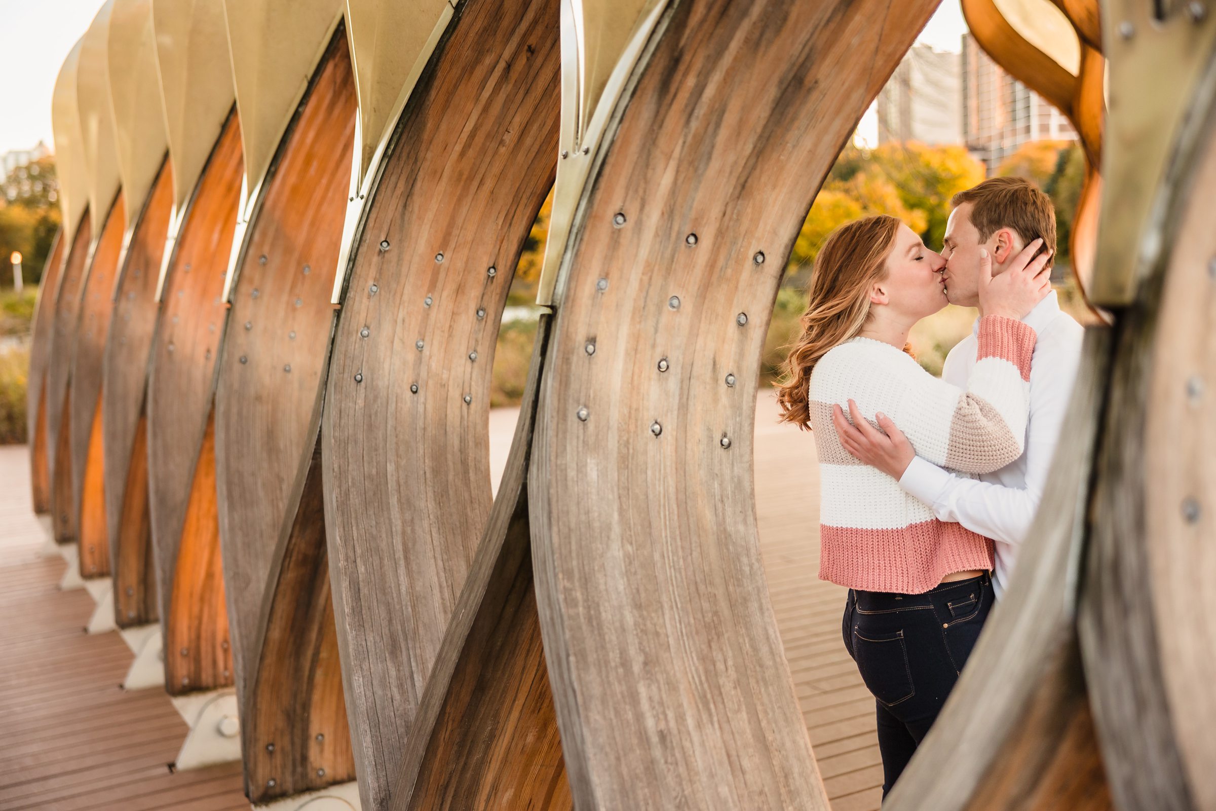 Couple kiss during their engagement sessionat Lincoln Park in Chicago, Illinois.