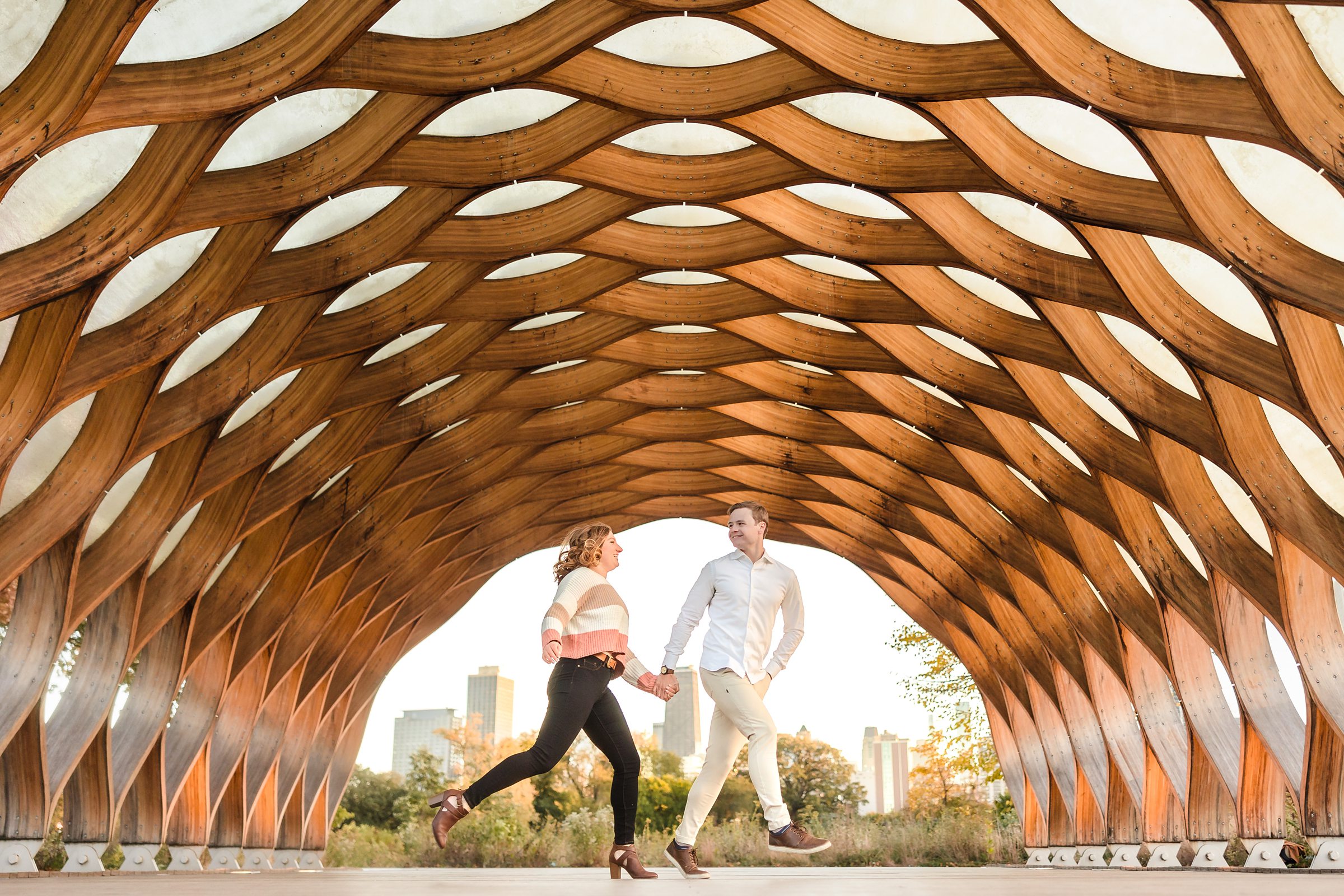 Couple walk together during their engagement sessionat Lincoln Park in Chicago, Illinois.