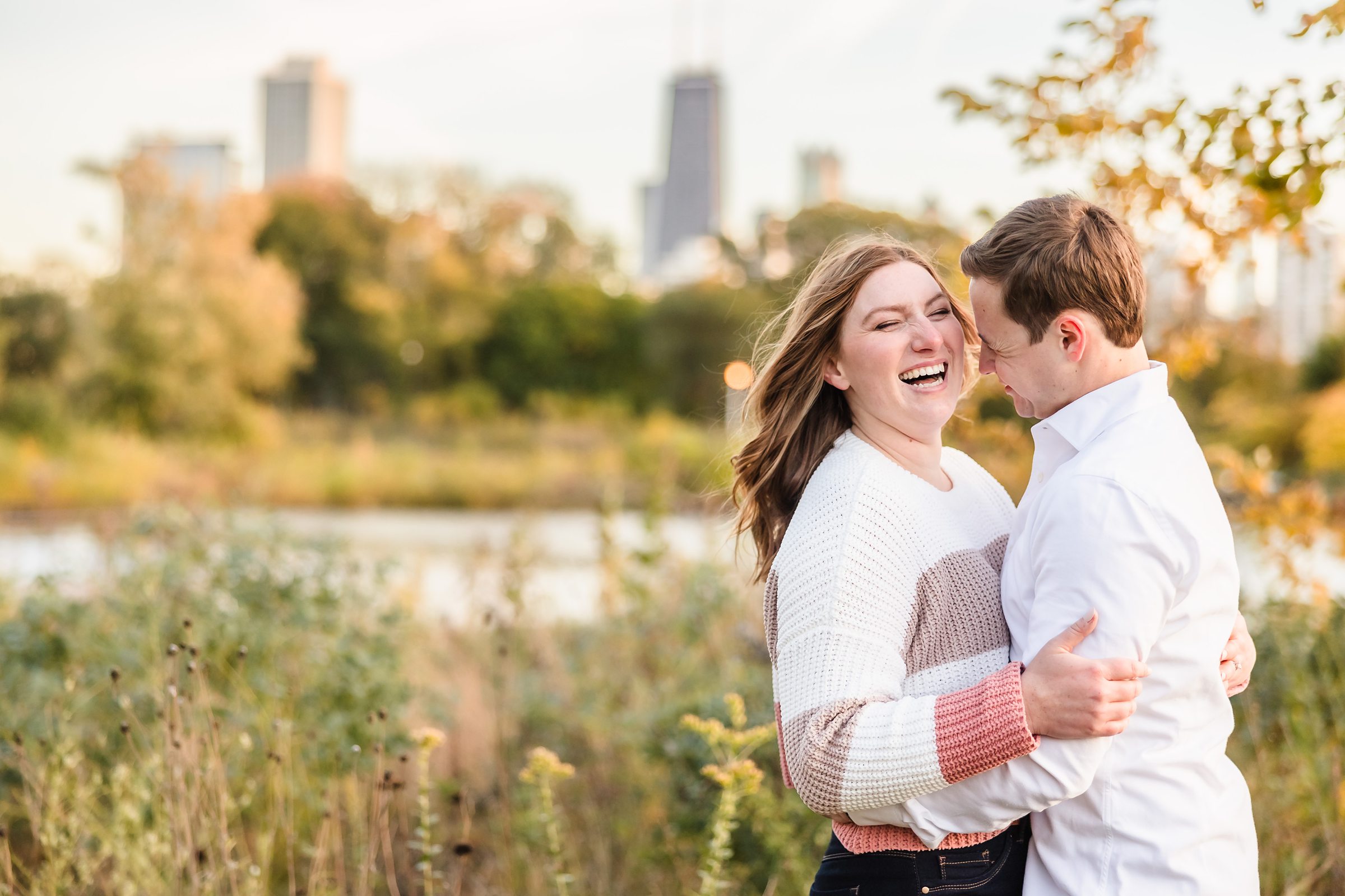 Couple embrace during their engagement sessionat Lincoln Park in Chicago, Illinois.