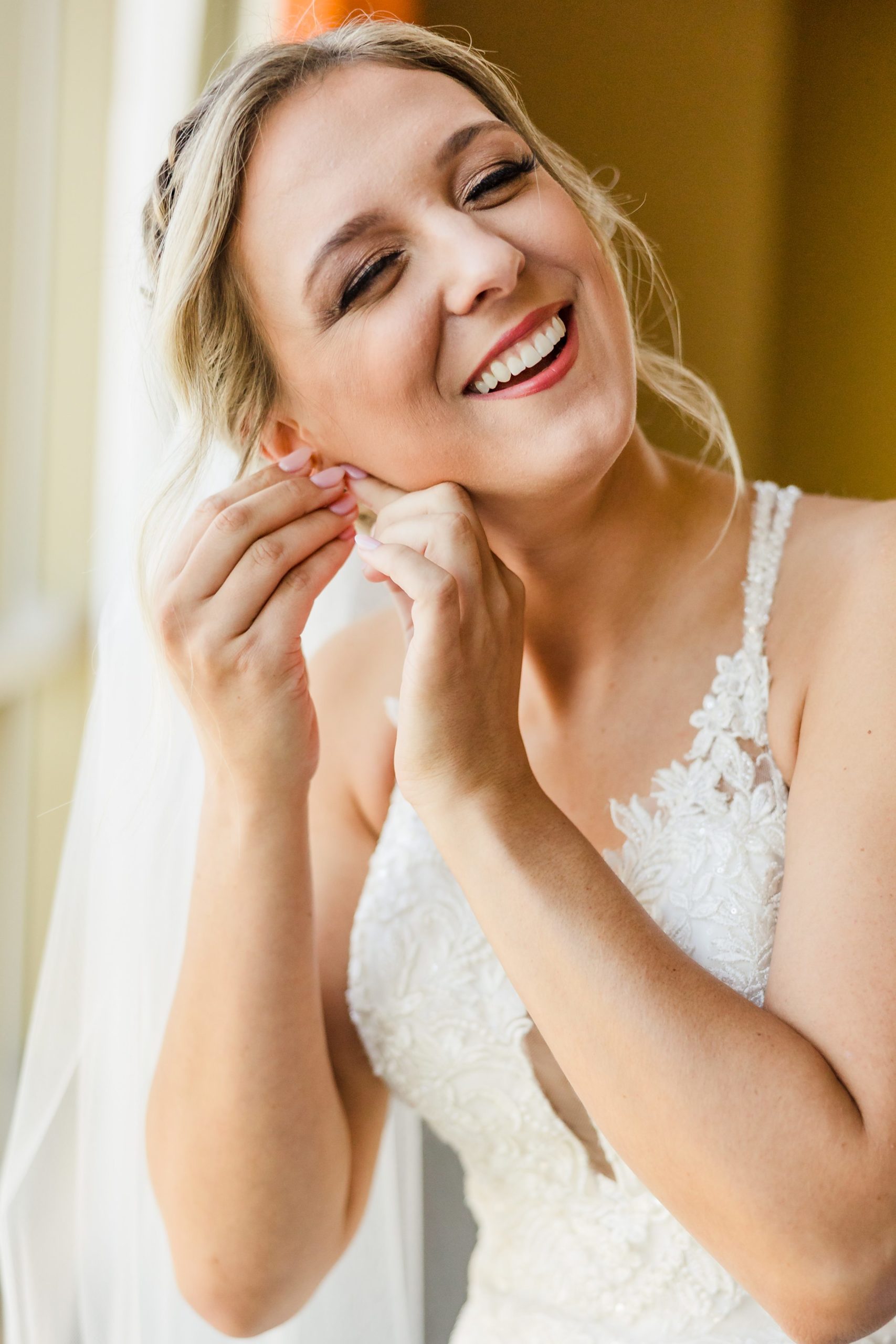 Bride puts in her ear rings before her wedding at the Luthy Botanical Garden in Peoria, Illinois