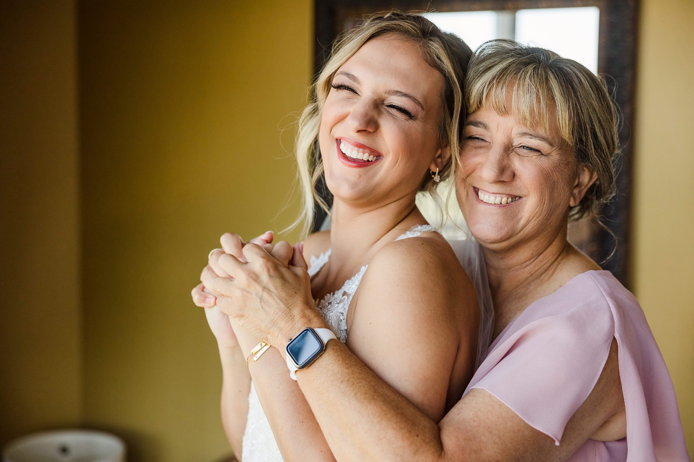 Bride's mother hugs her before a wedding at the Luthy Botanical Garden in Peoria, Illinois