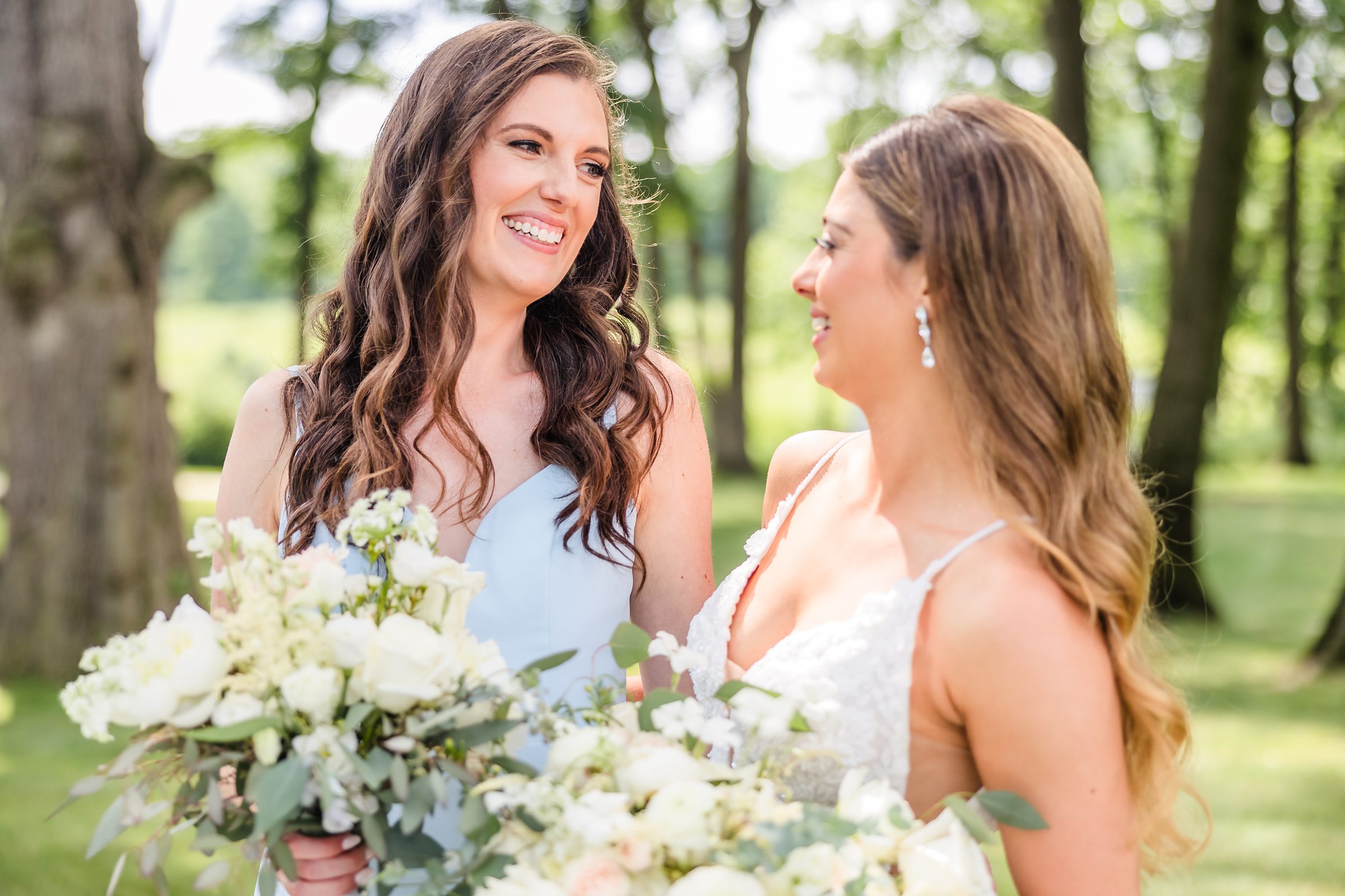 Bride celebrates with bridesmaid during her wedding with their bridal party at the Monte Bello Estate in Lemont, Illinois.