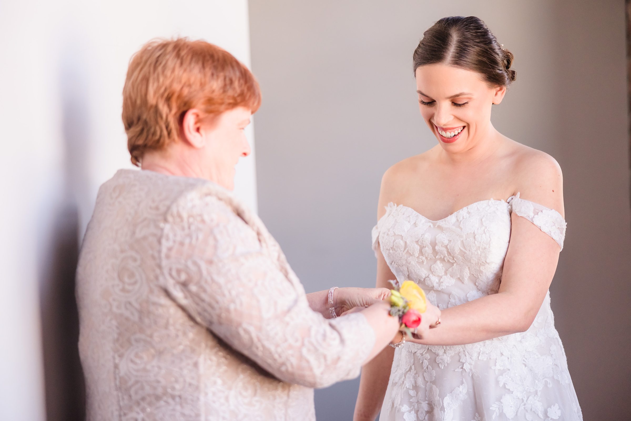 Mom helps the bride get ready for her wedding at the Trailside Event Center in Peoria Heights, Illinois.