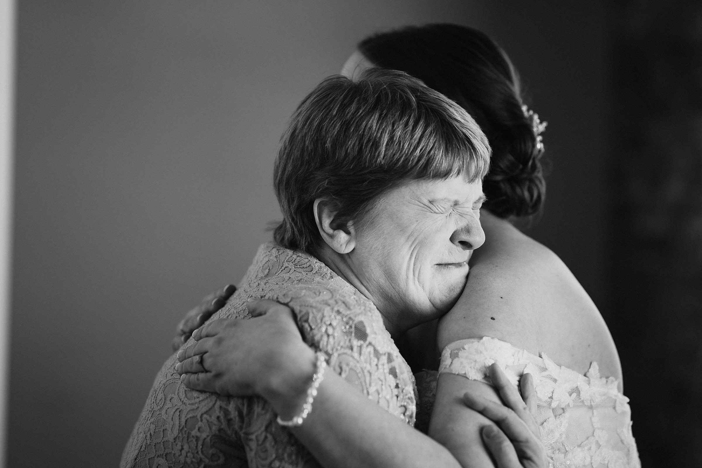 Bride hugs her mother before her wedding at the Trailside Event Center in Peoria Heights, Illinois.