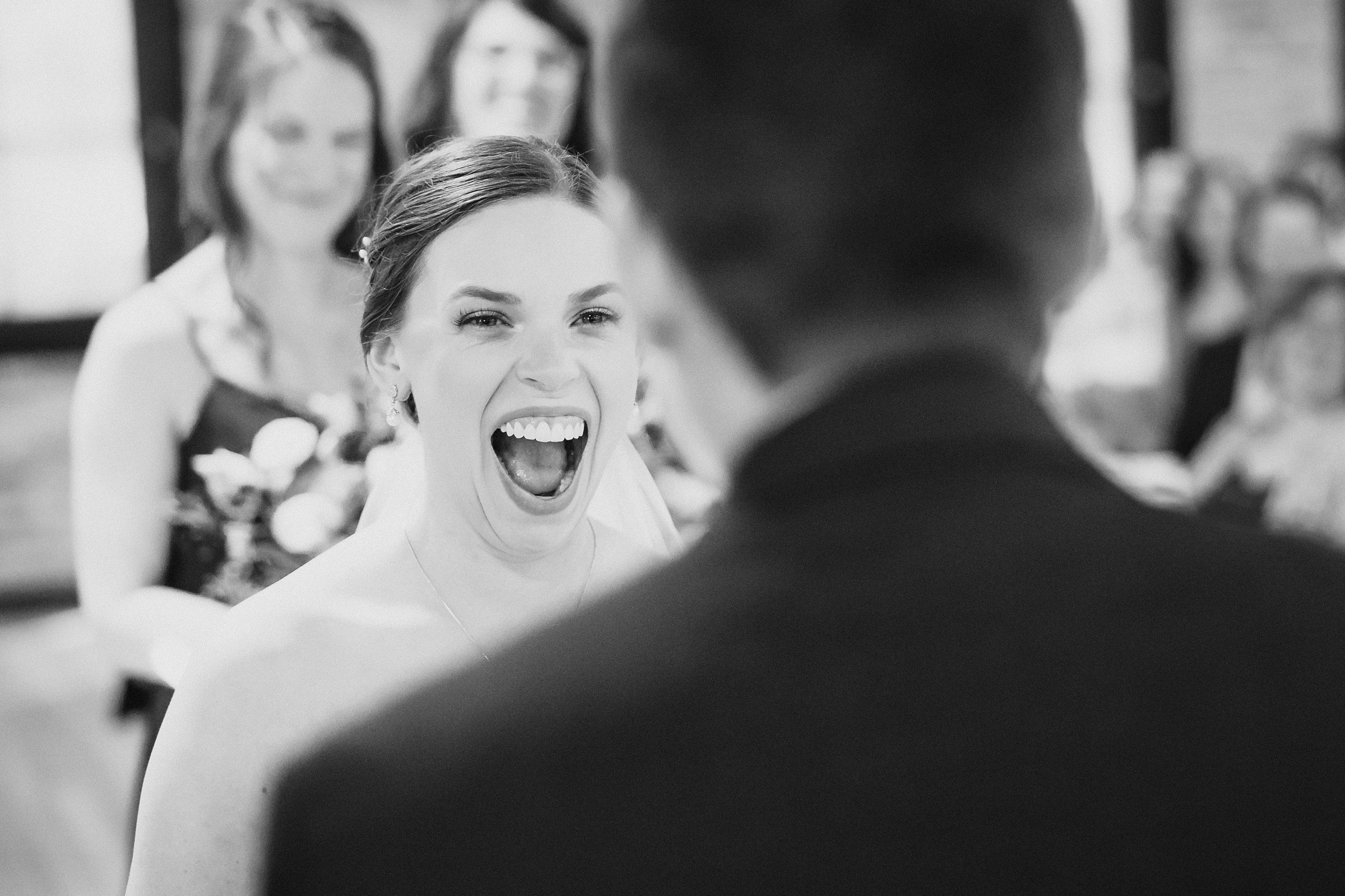 Bride laughs during a wedding ceremony at the Trailside Event Center in Peoria Heights, Illinois.