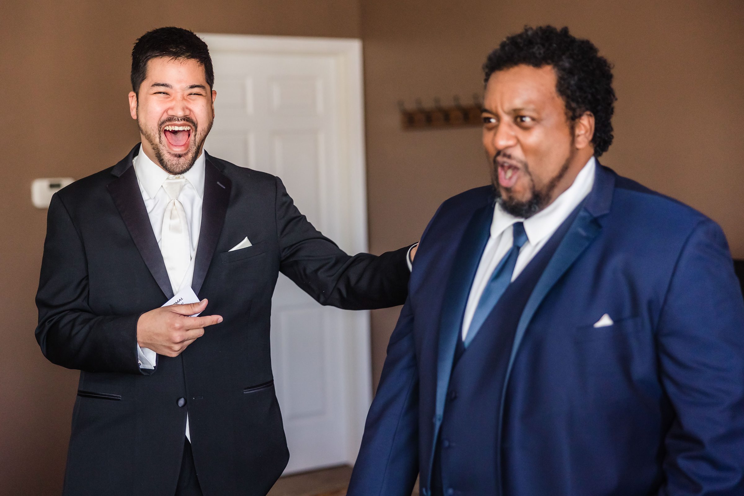 Groom jokes around with a groomsmen during his wedding at the Ritz Charles in Carmel, Indiana.