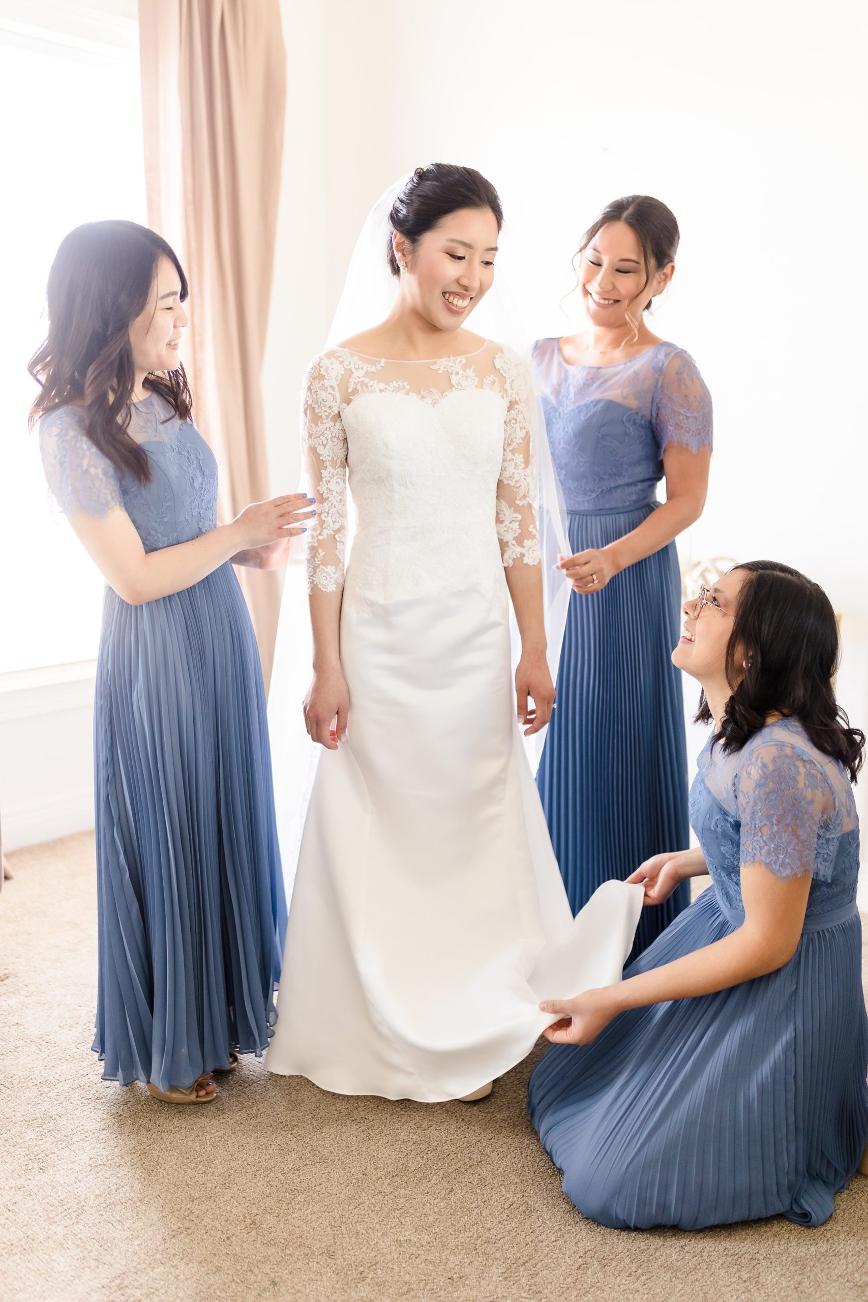 Bridesmaids help the bride get ready for her wedding at the Ritz Charles in Carmel, Indiana.