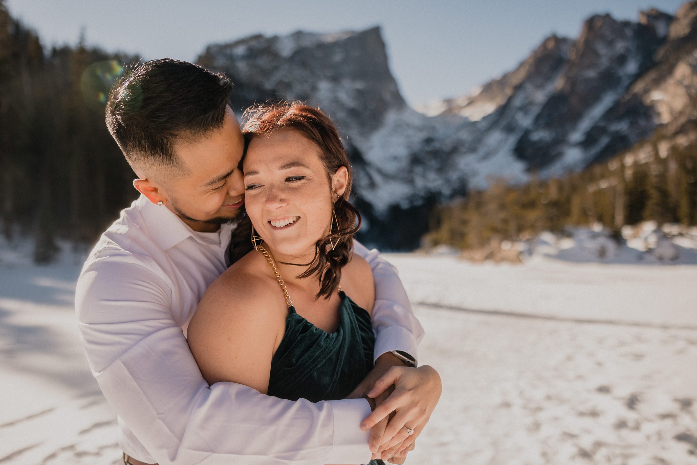 Couple embrace during their Rocky Mountain National Park Engagement session